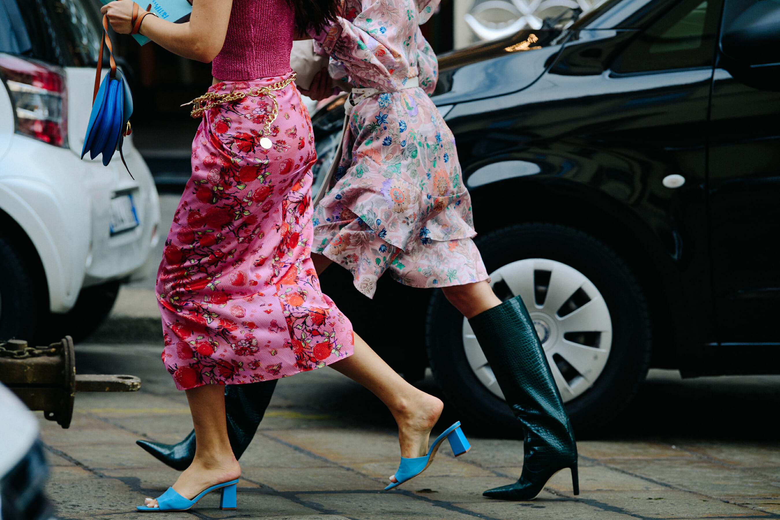 Two women wearing floral skirts