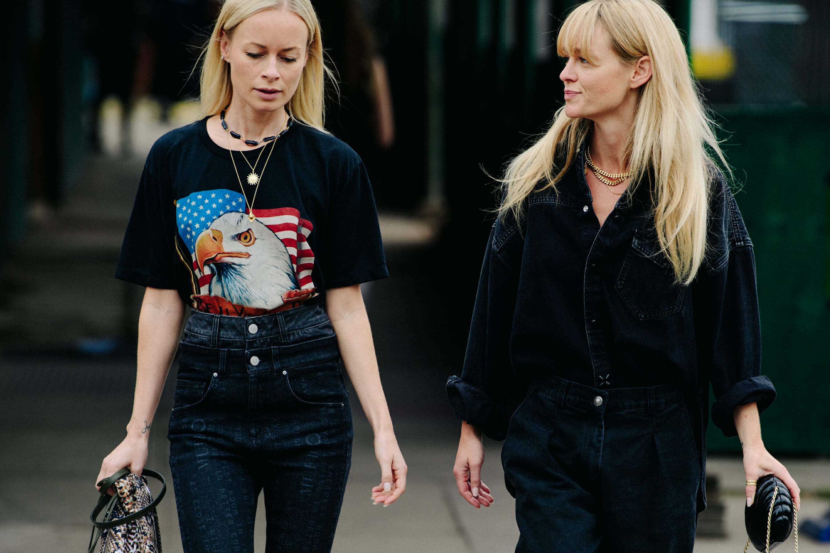 Two women wearing black clothing