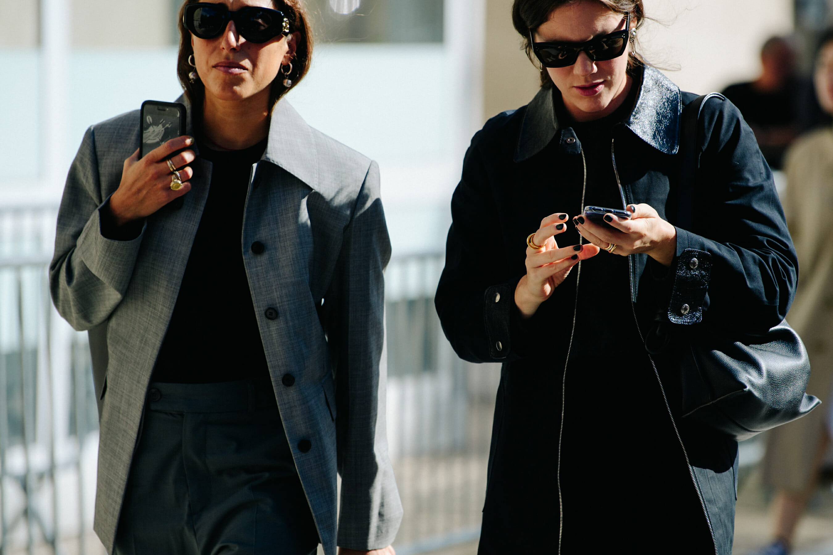 Two women wearing grey coats