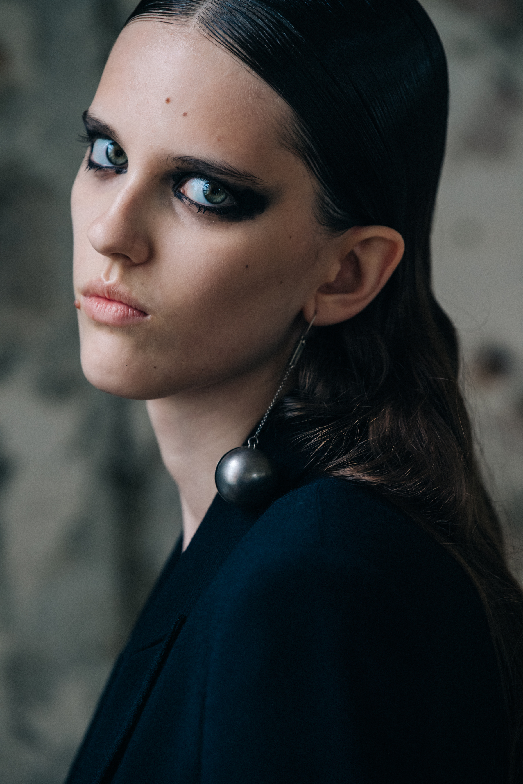 Portrait of model wearing long chain earring