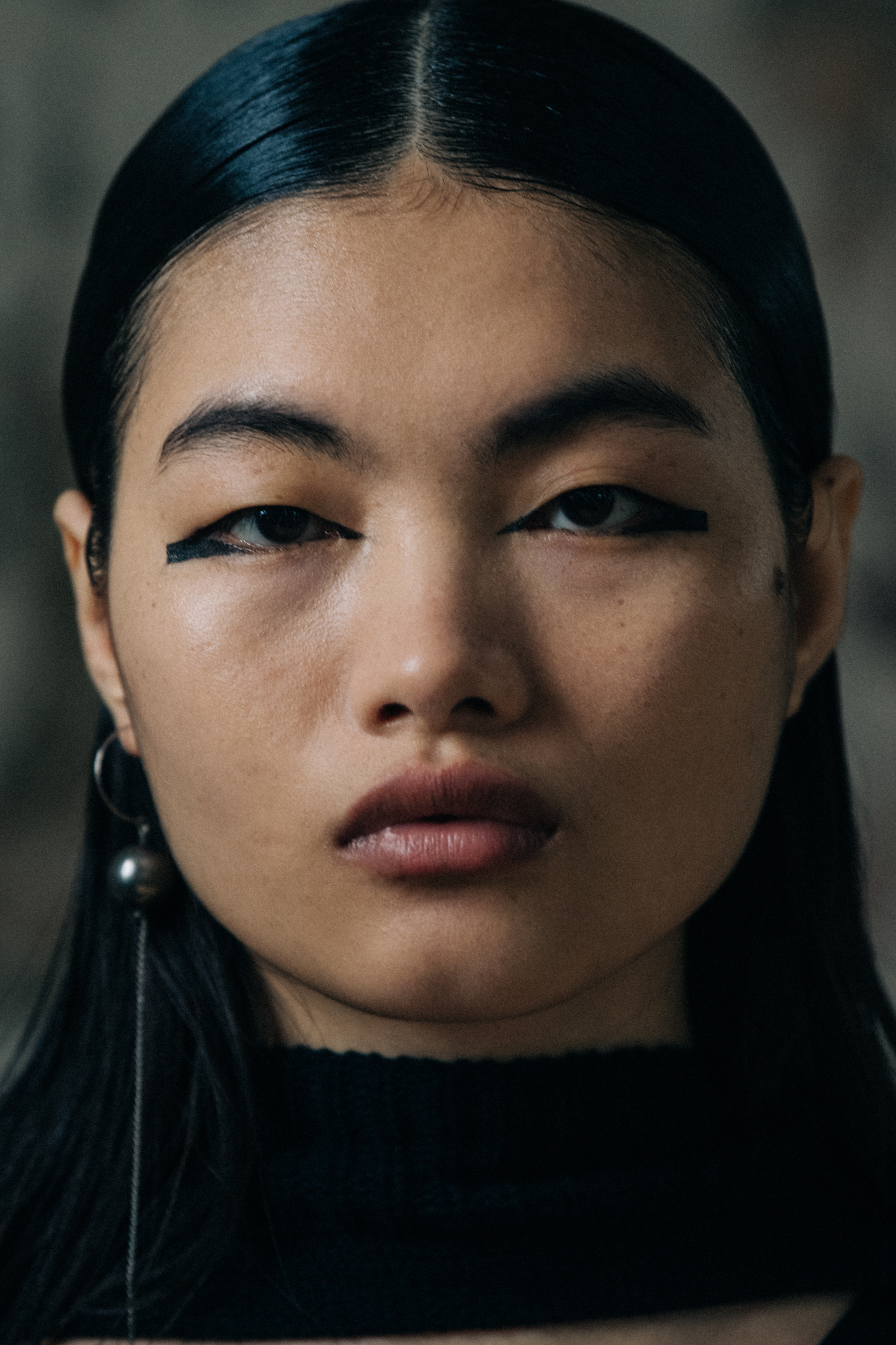 Portrait of model wearing dark eye makeup