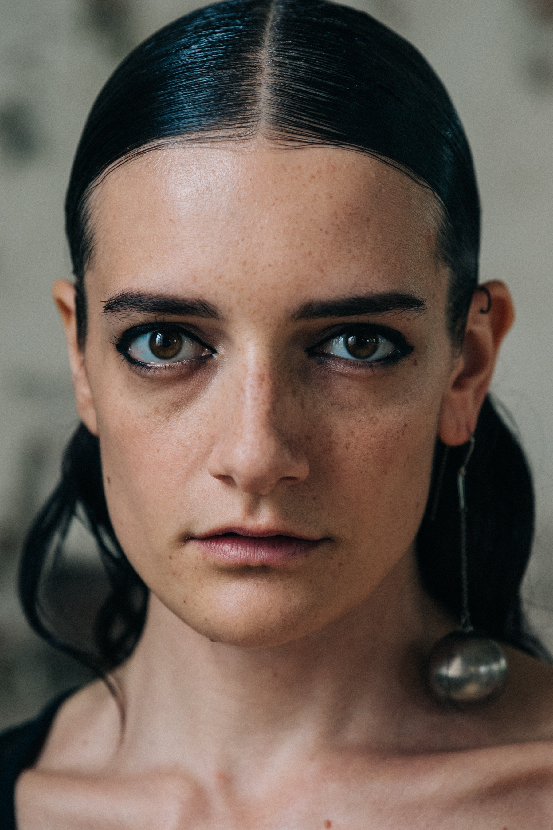 Portrait of model wearing long chain earring