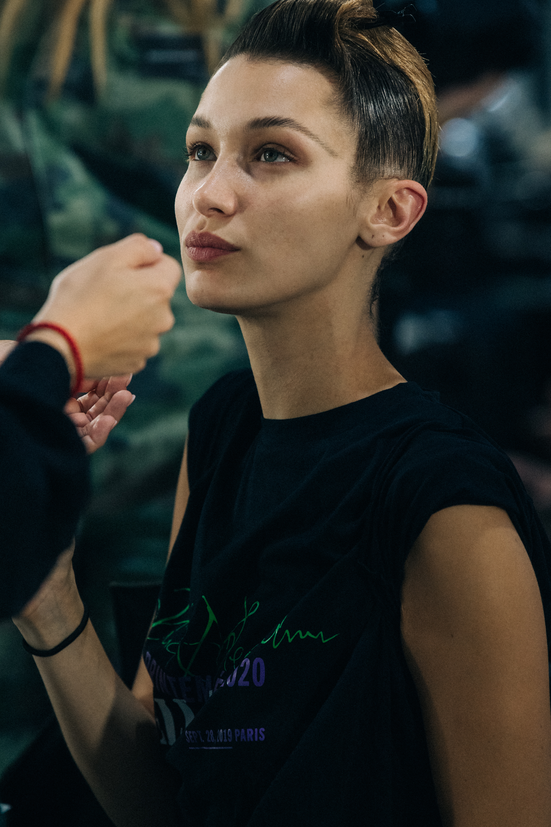 Model backstage wearing green dress