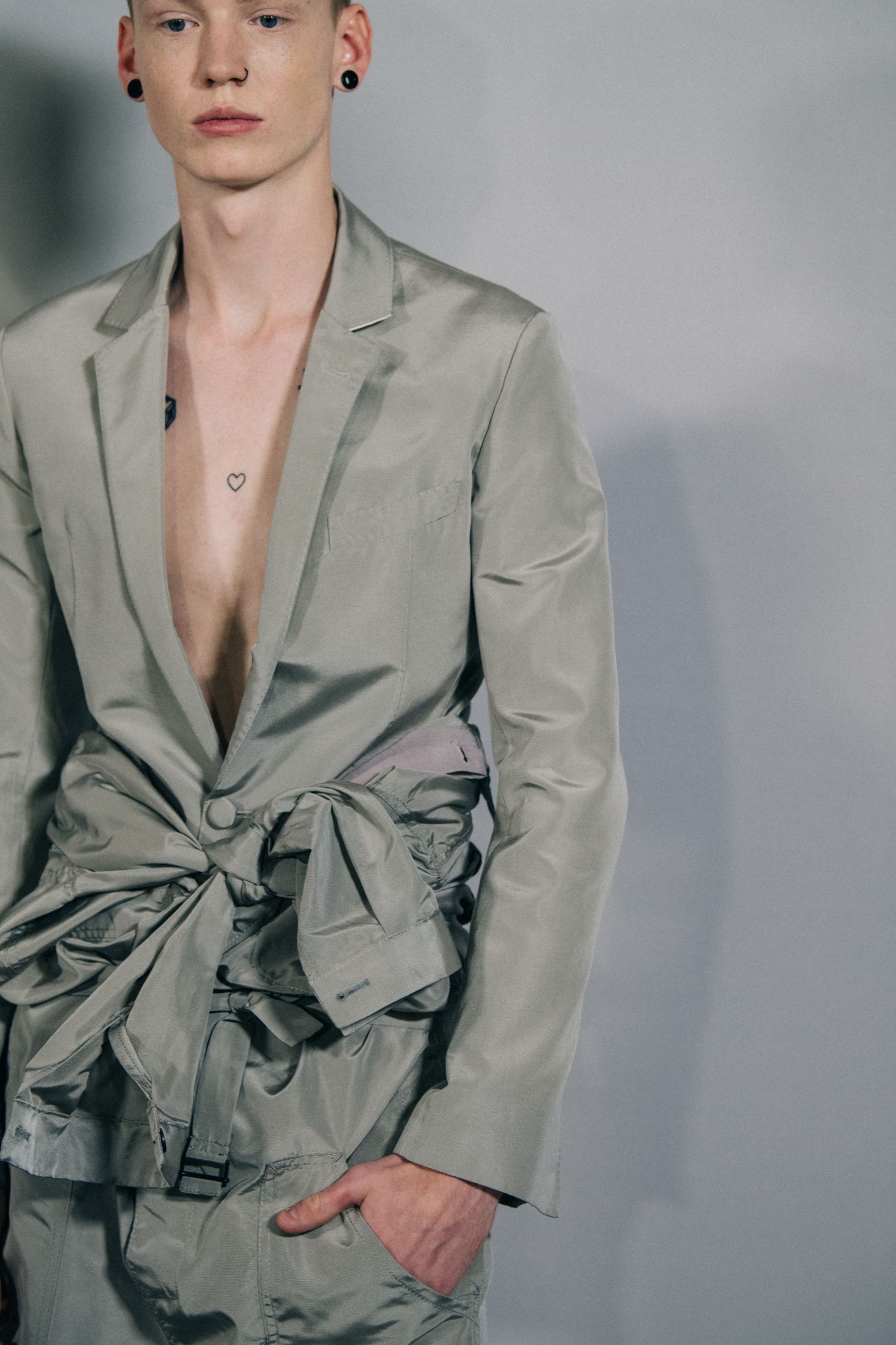 Model wearing grey jacket at Haider Ackermann