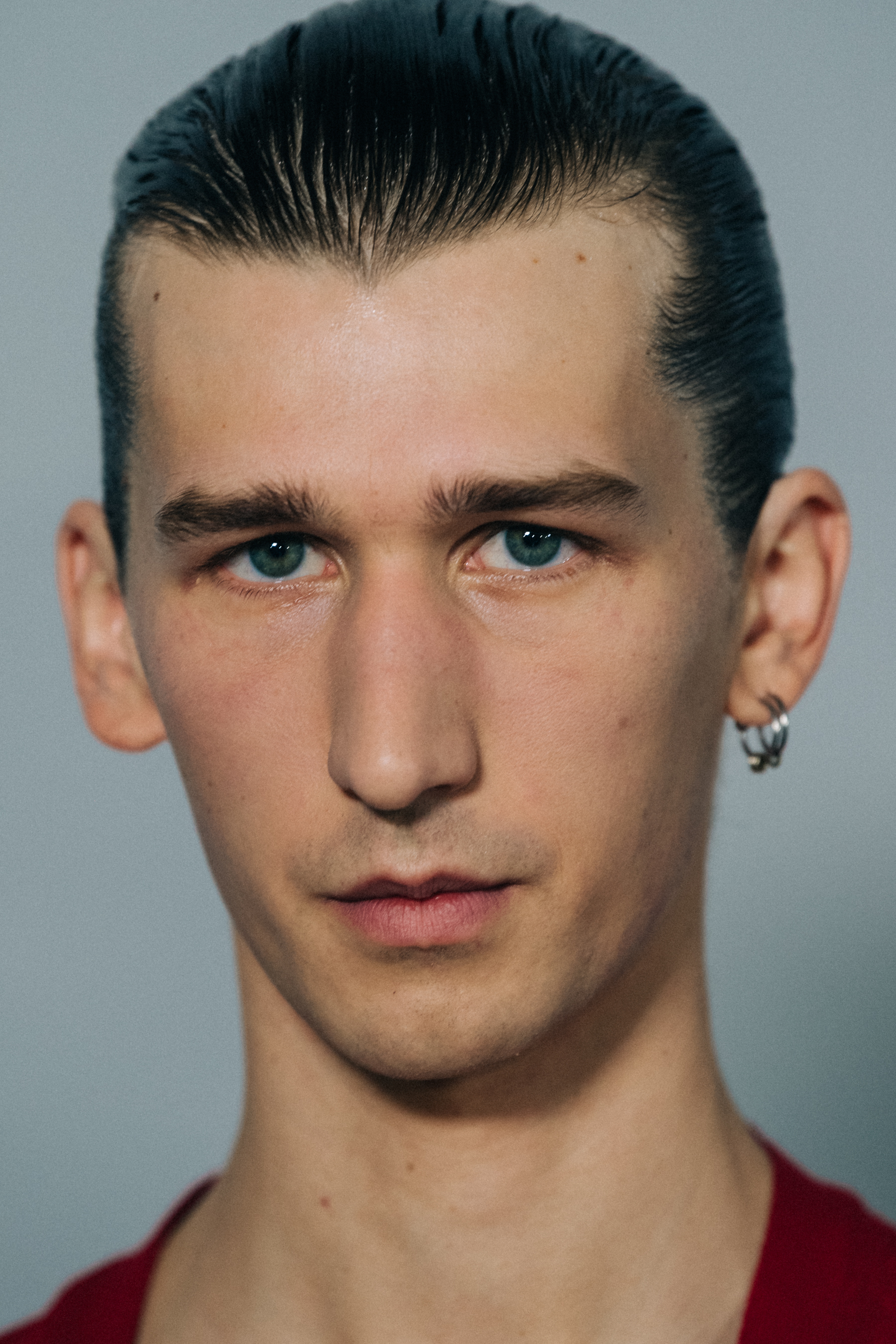 Model wearing red open shirt backstage