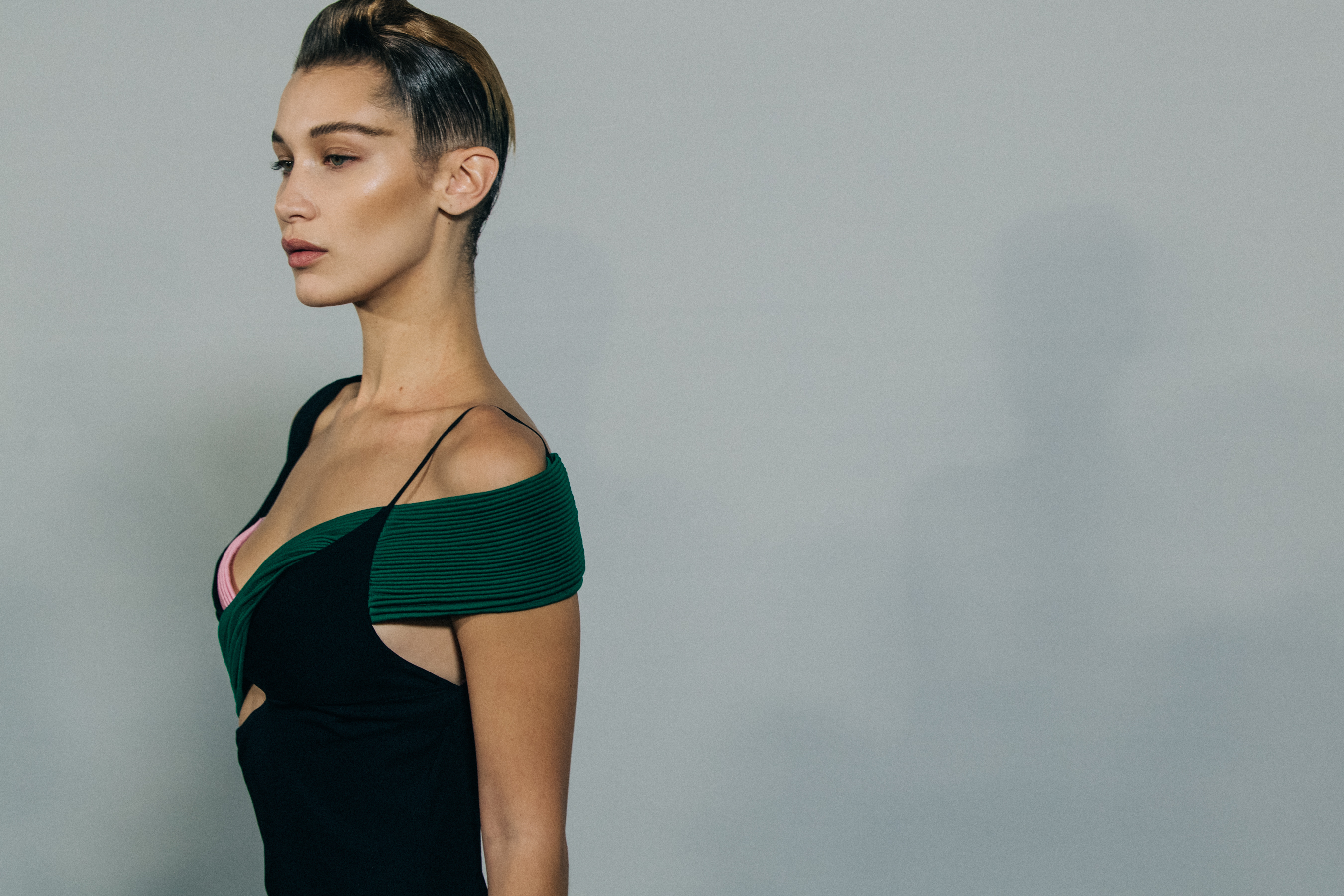 Model backstage wearing green dress