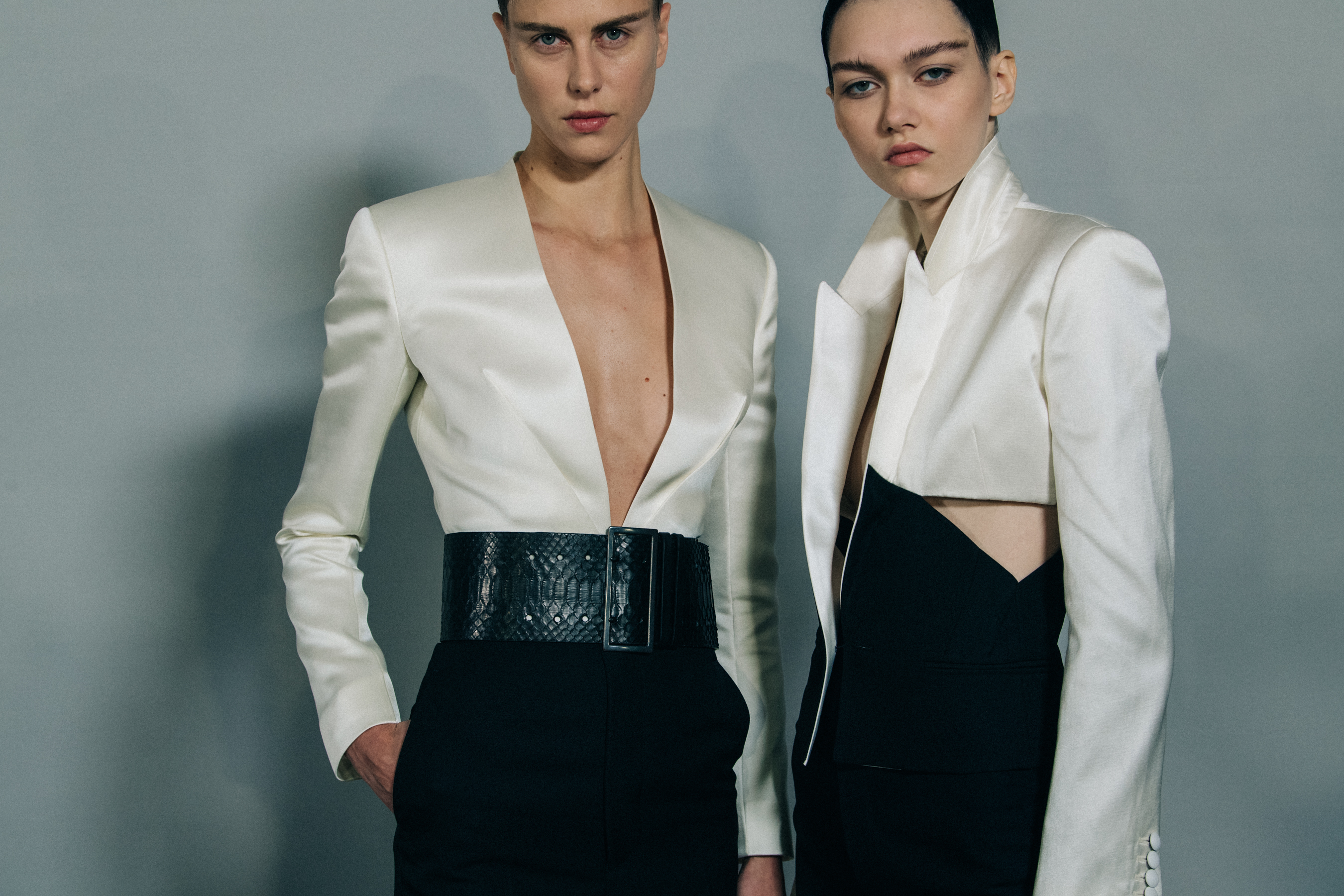 Model wearing white jacket backstage at Haider Ackermann