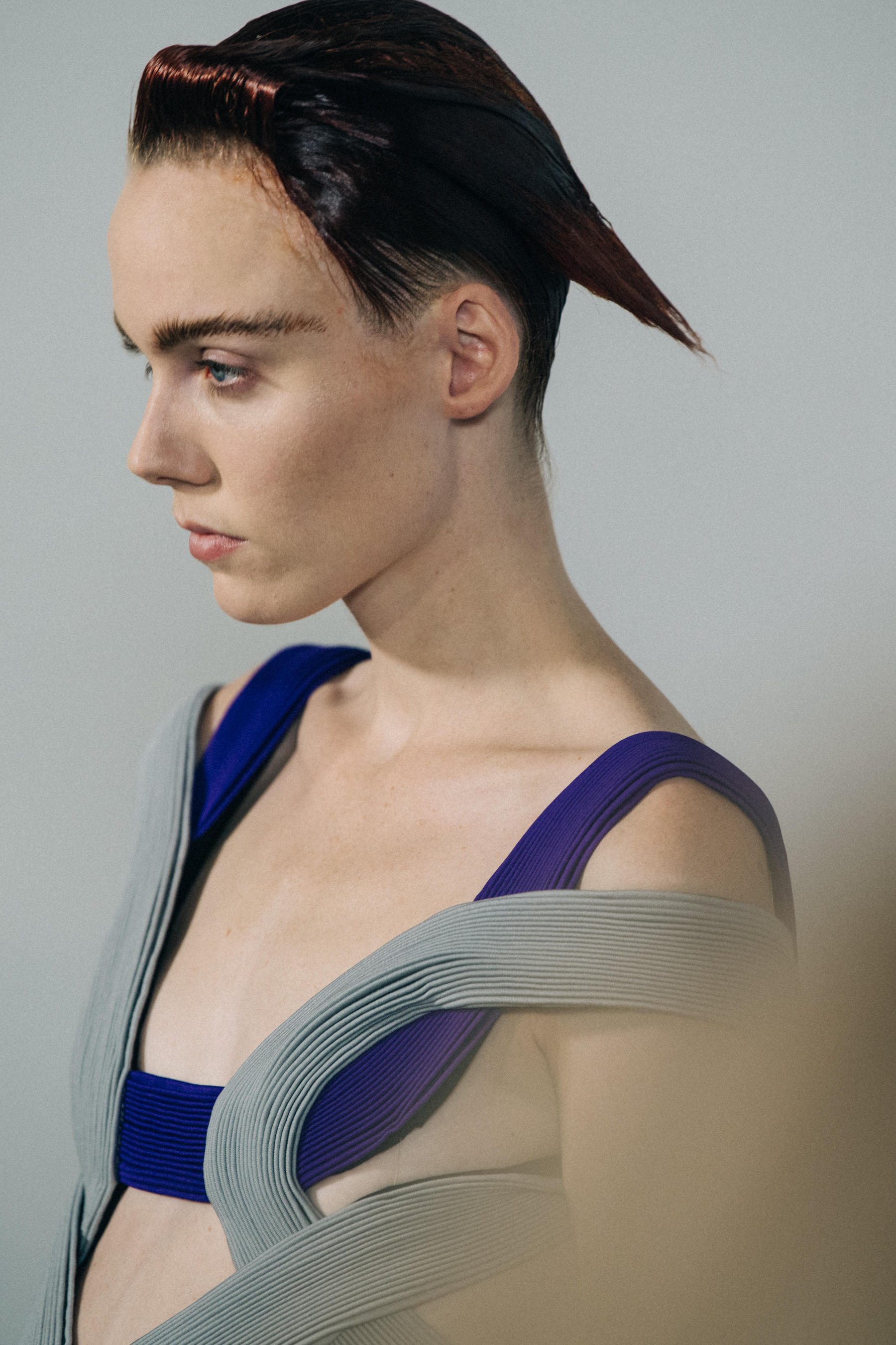 Model backstage wearing grey dress