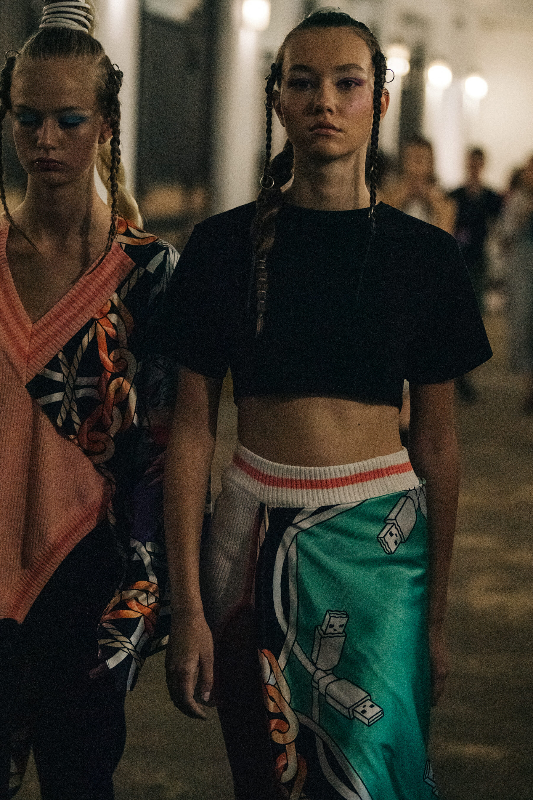 Models wearing colourful outfits backstage
