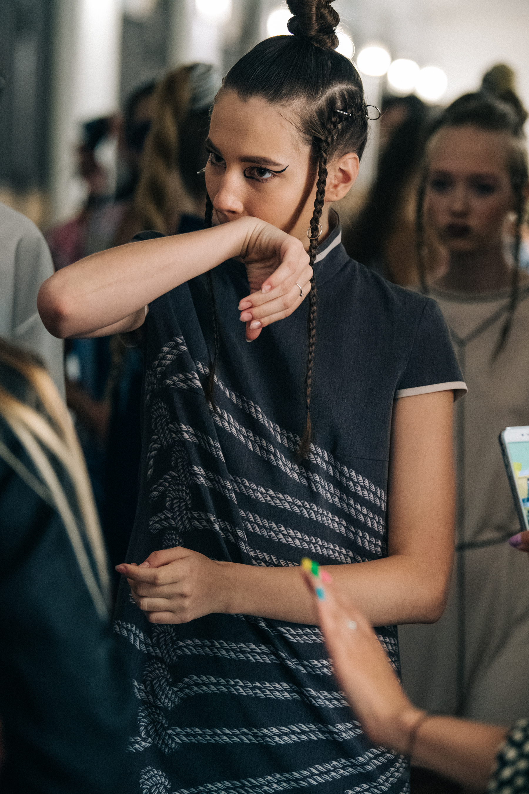 Model wearing dark outfit backstage