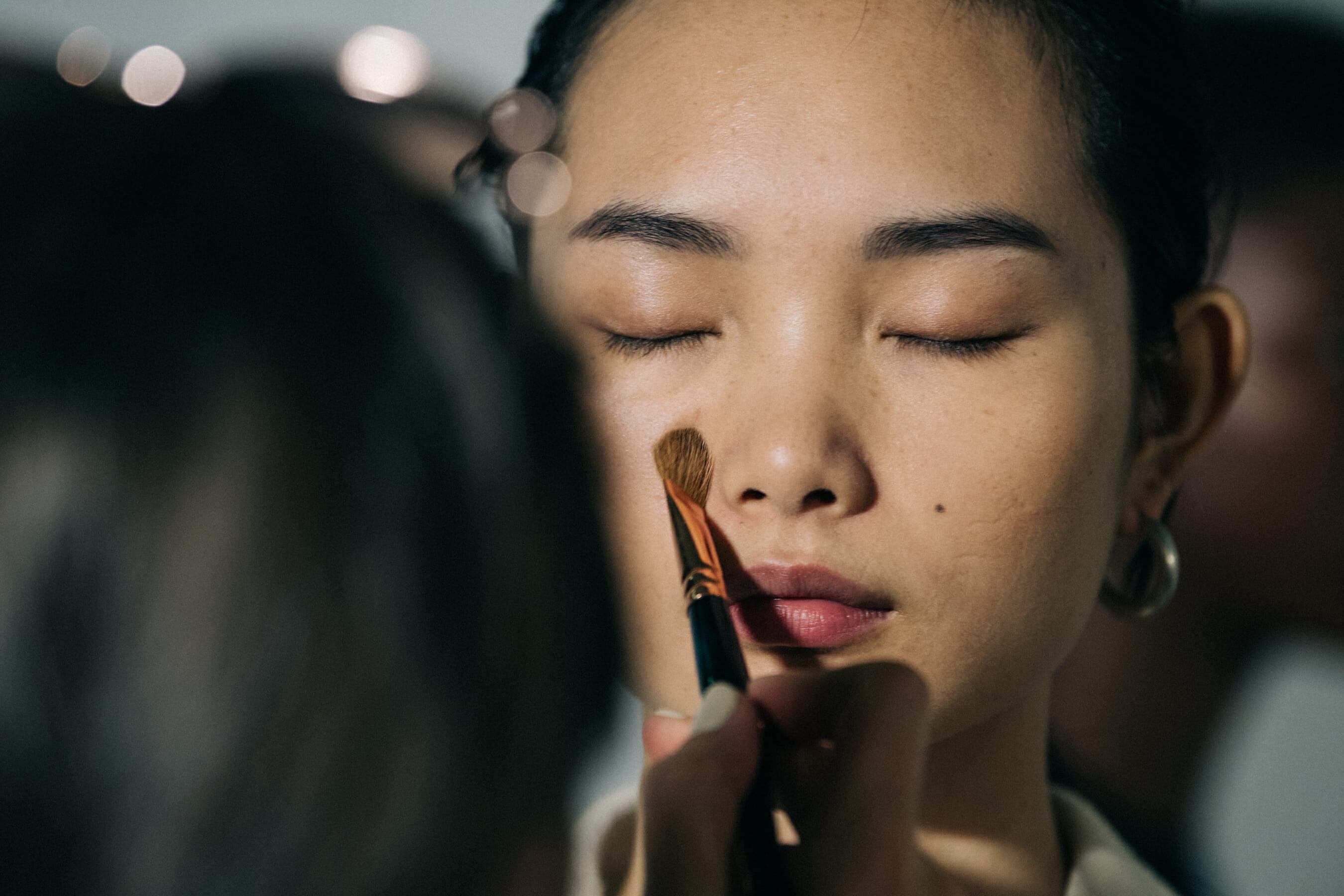 Models in hair and makeup at Jil Sander