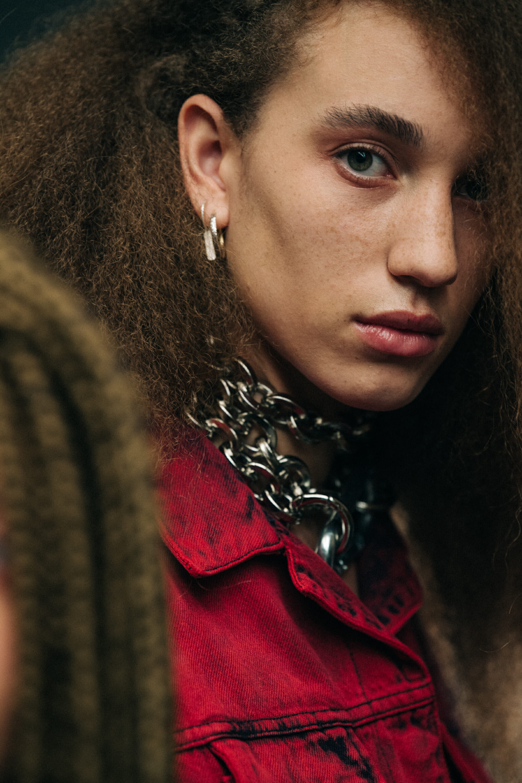Model wearing red backstage at Marques Almeida