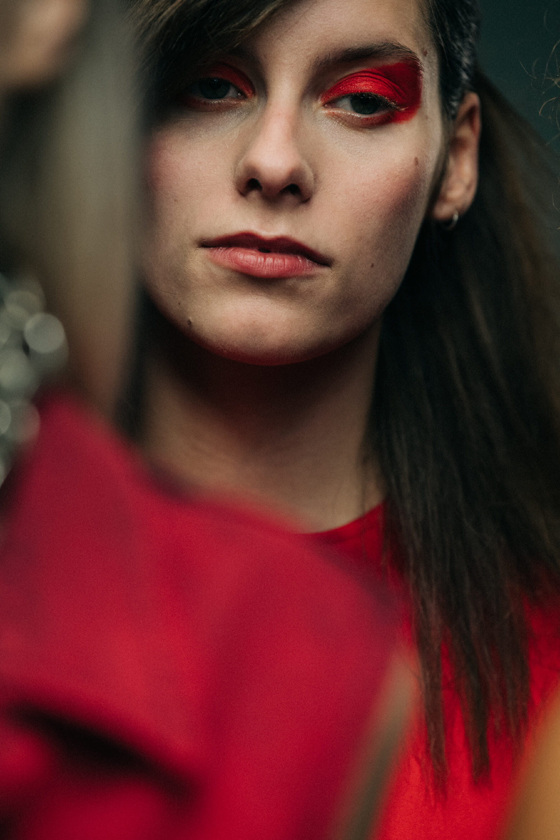 Model wearing red backstage at Marques Almeida