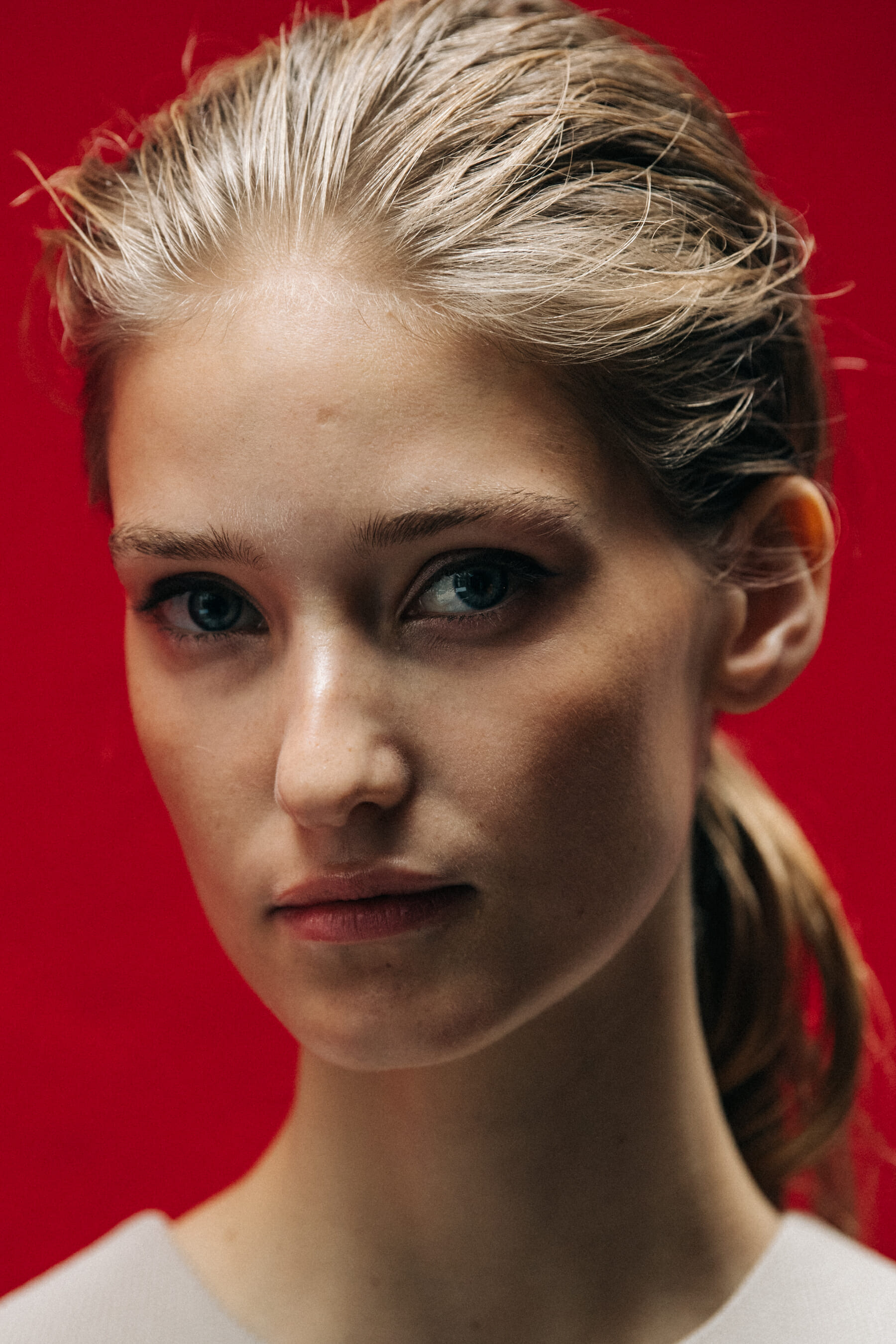Portrait of model against red wall