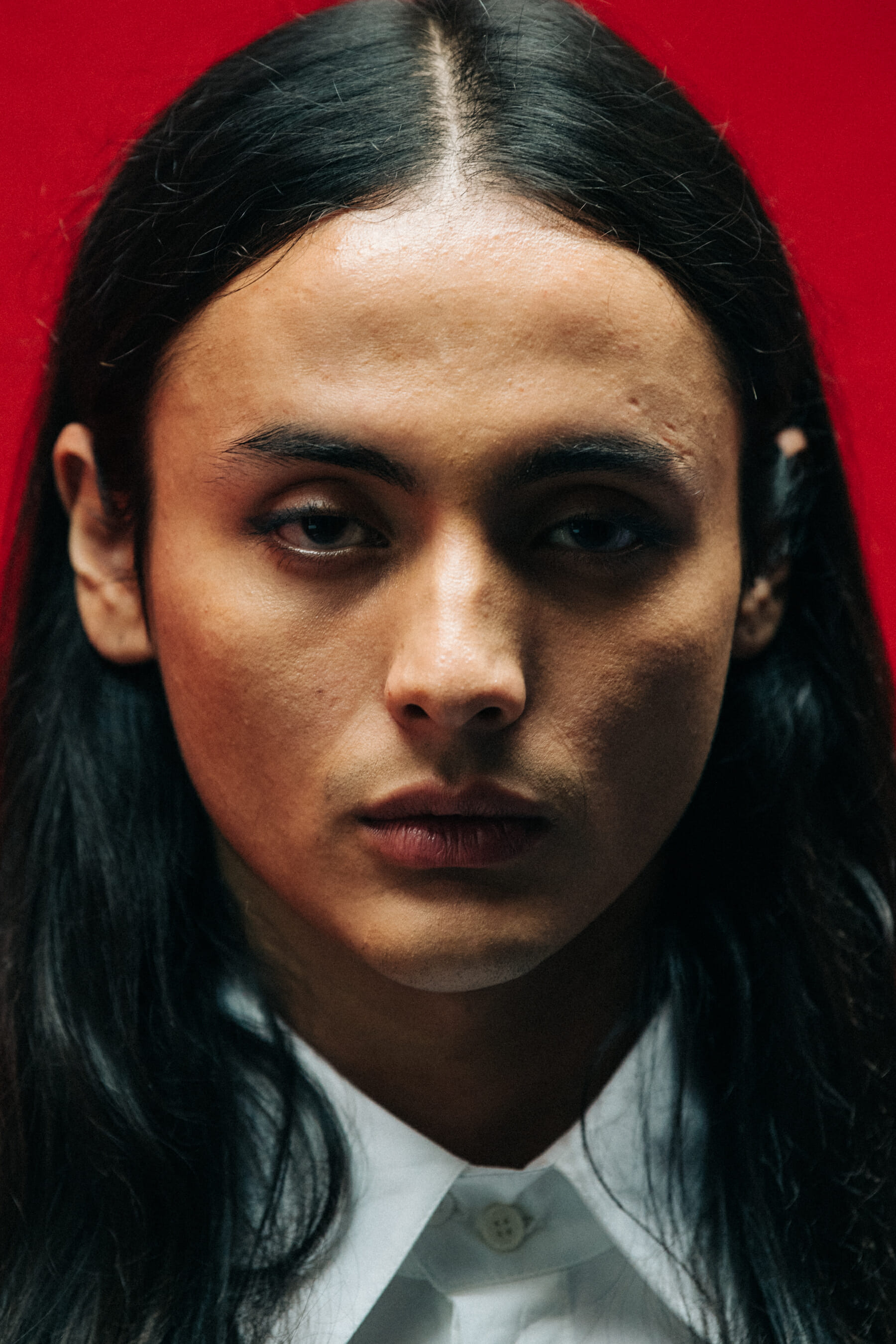 Portrait of model against red wall