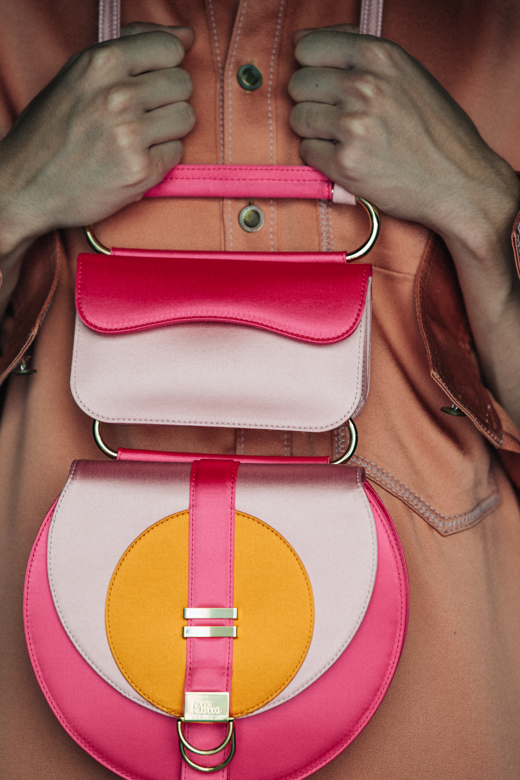 Model holding colourful bag