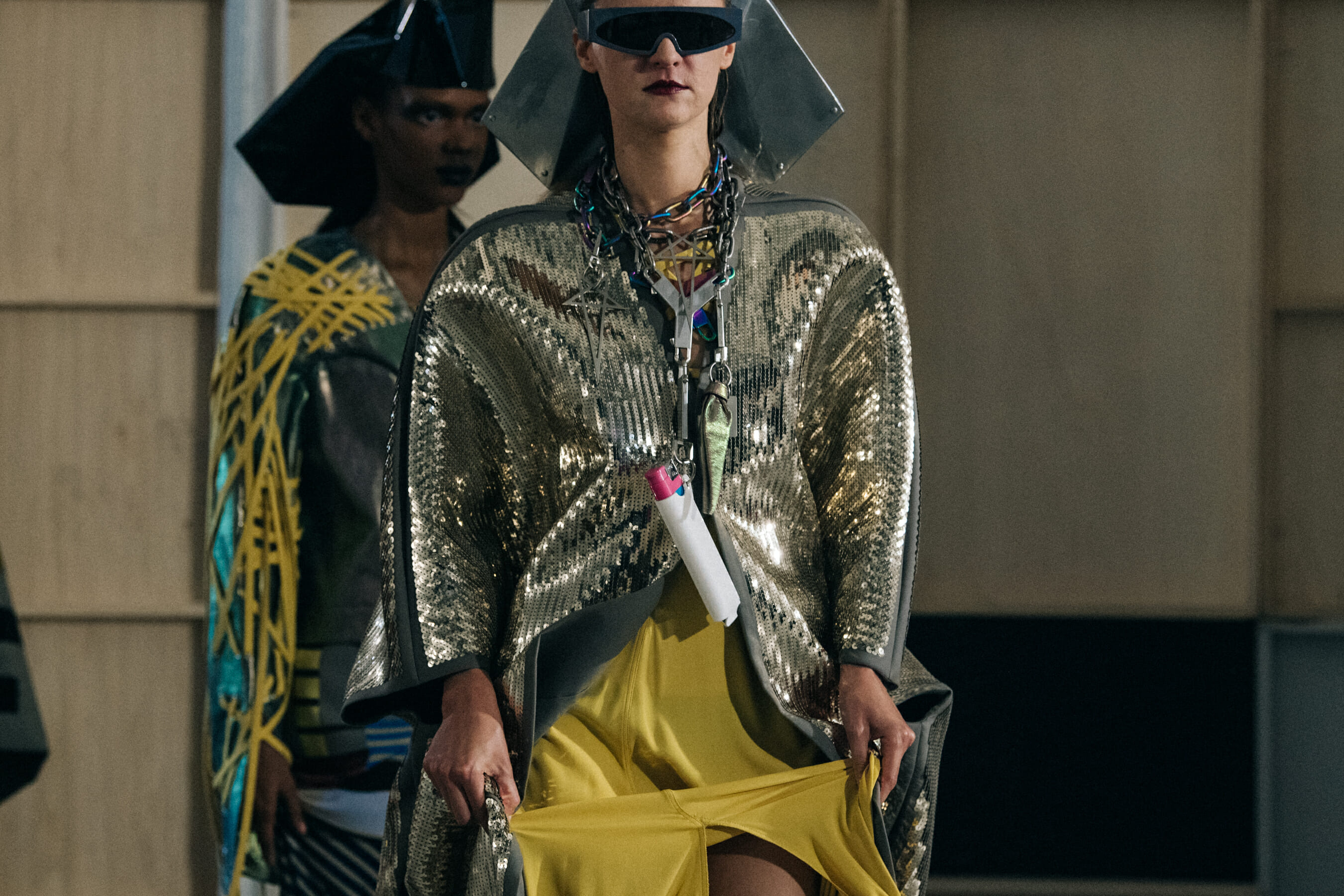 Models wearing helmets backstage at Rick Owens