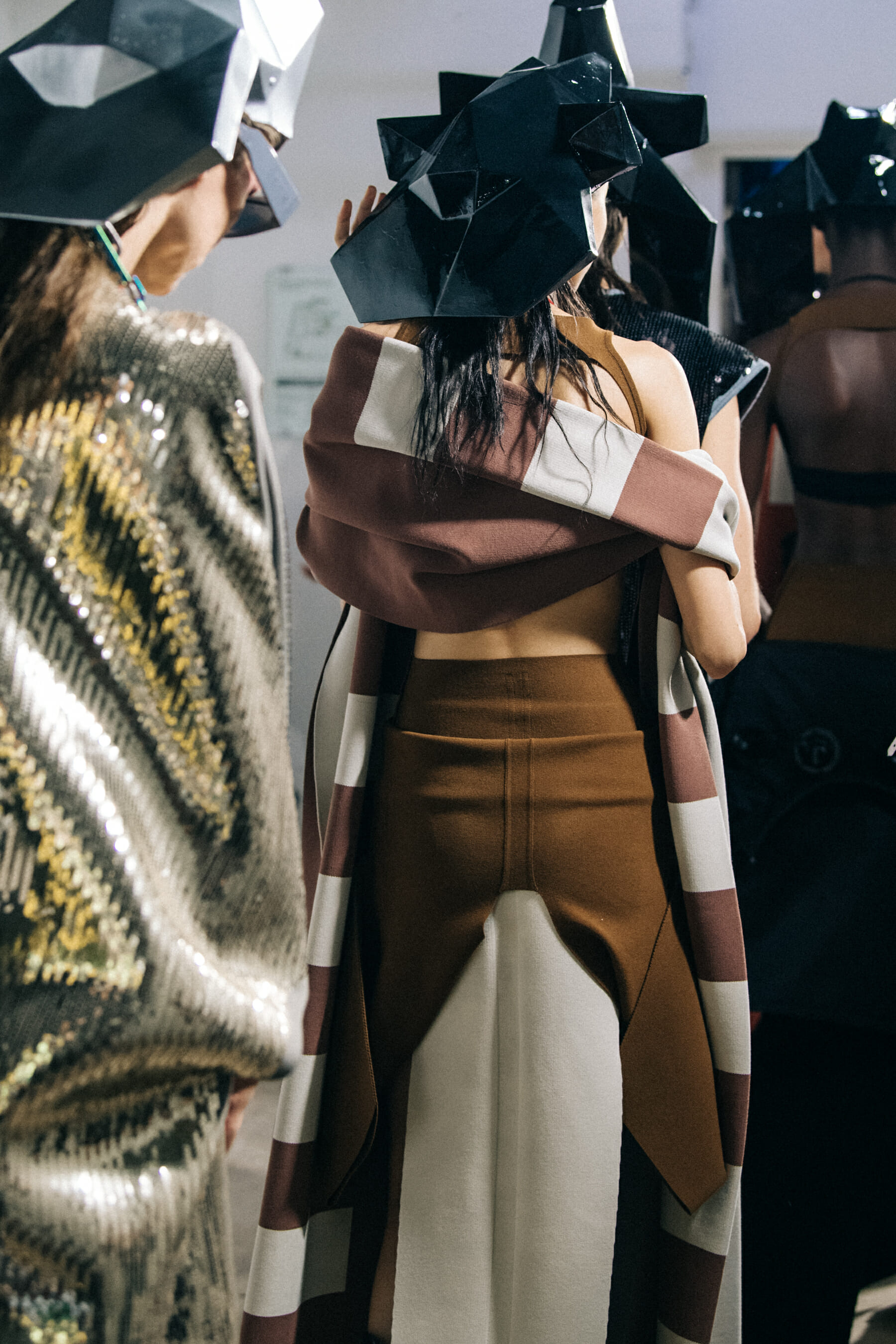 Models wearing helmets backstage at Rick Owens