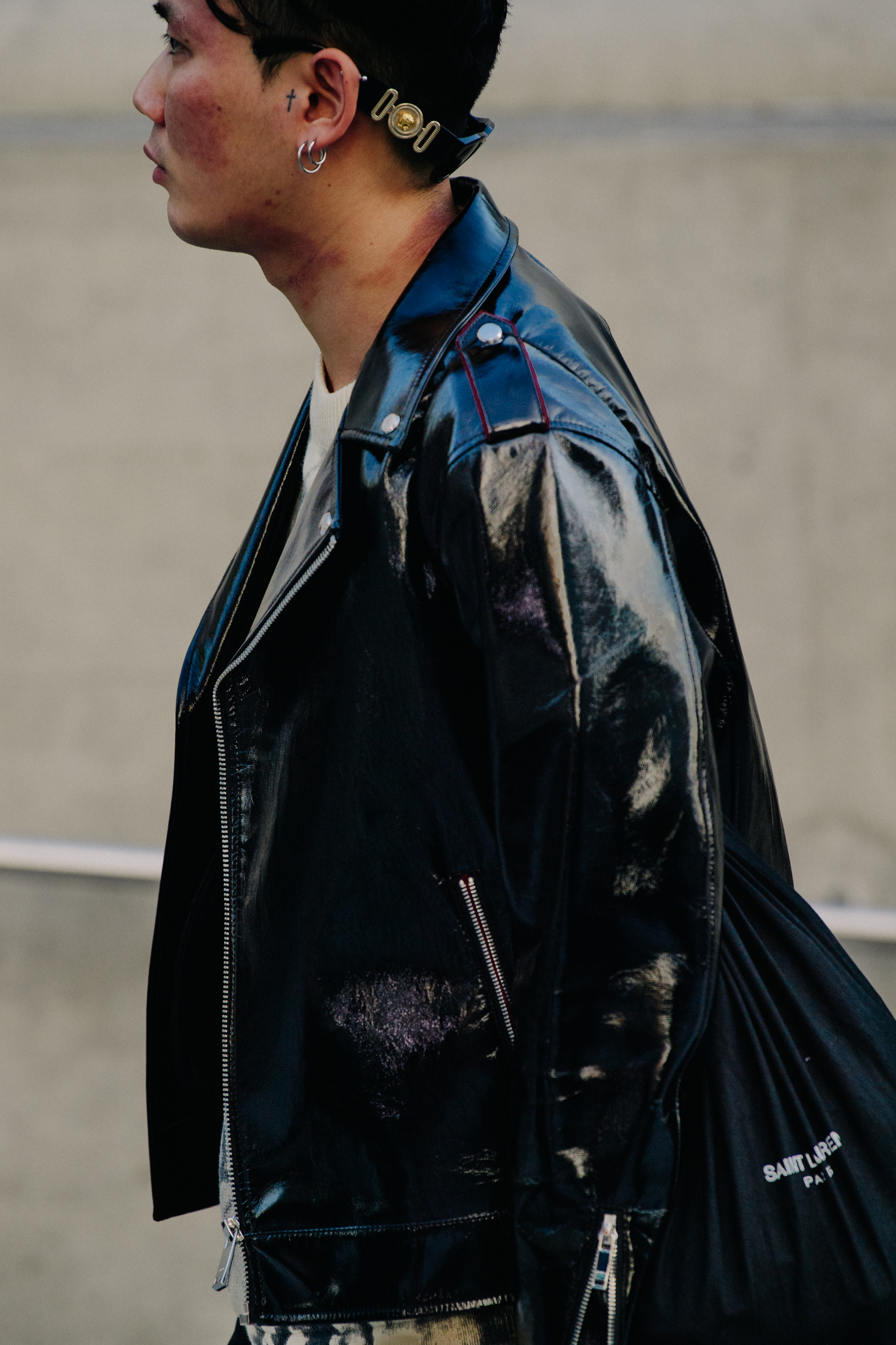 Man wearing black patent jacket