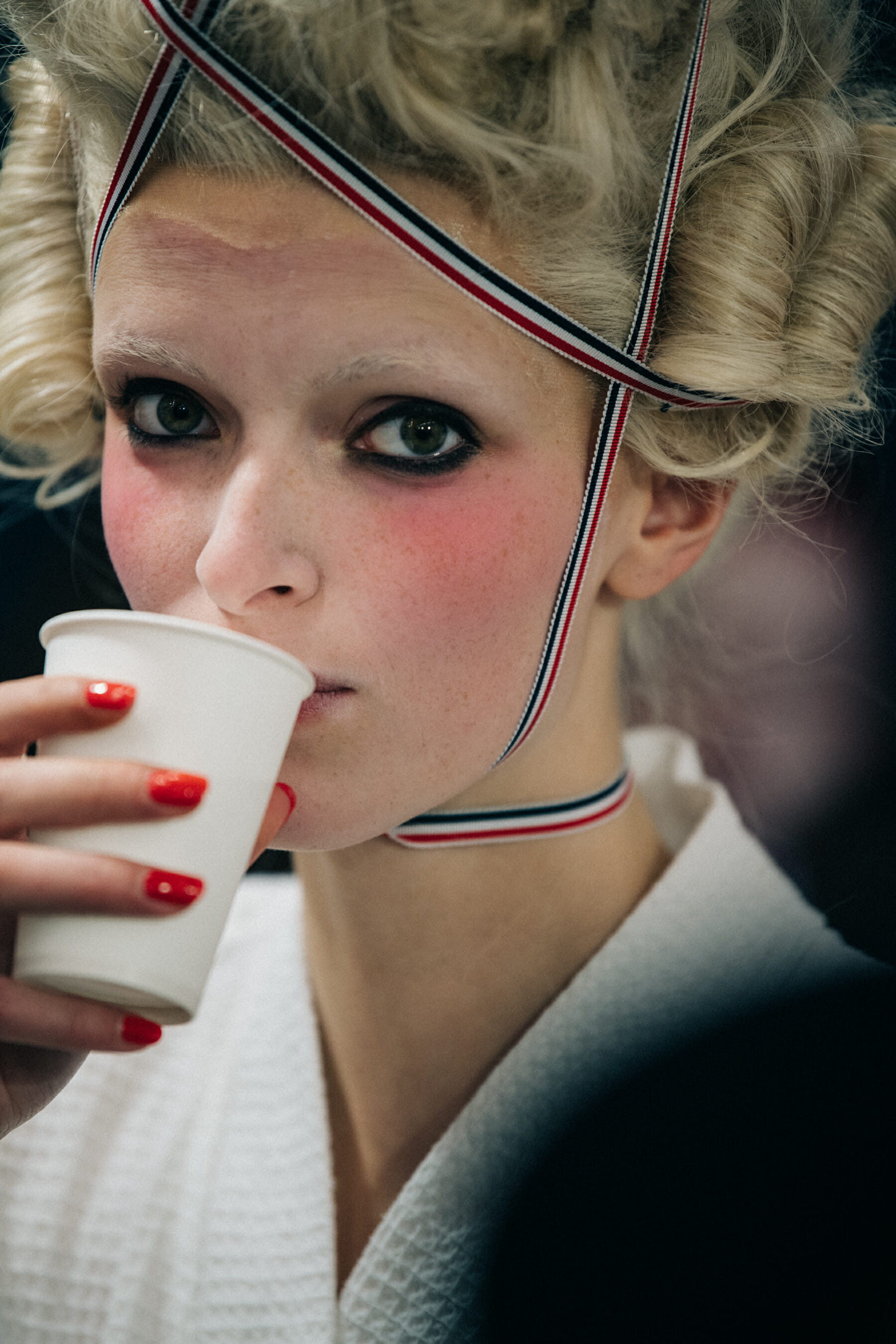 Models wearing tall wigs at Thom Browne
