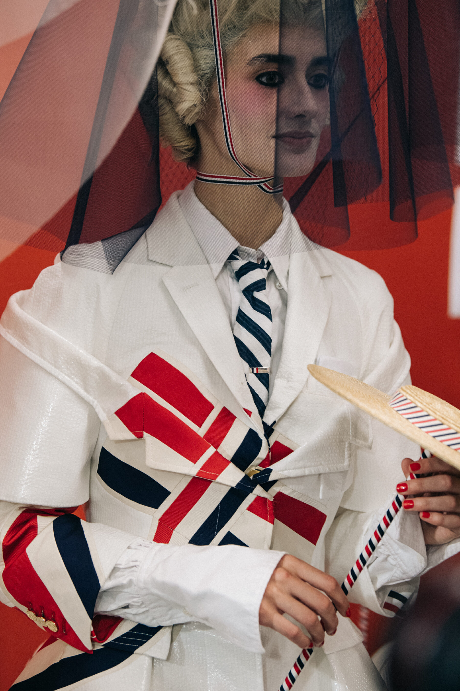 Models wearing tall wigs at Thom Browne