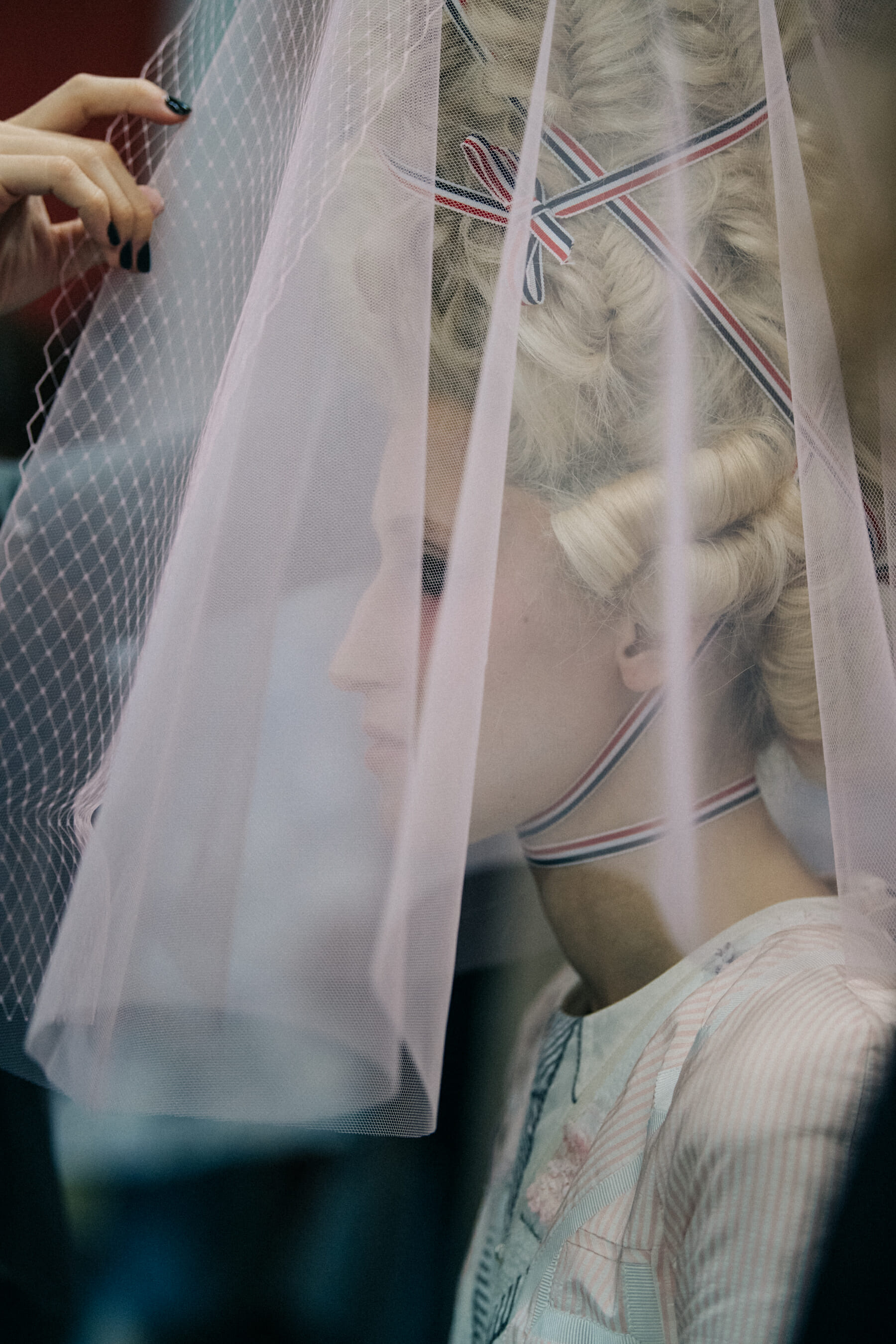 Models wearing tall wigs at Thom Browne