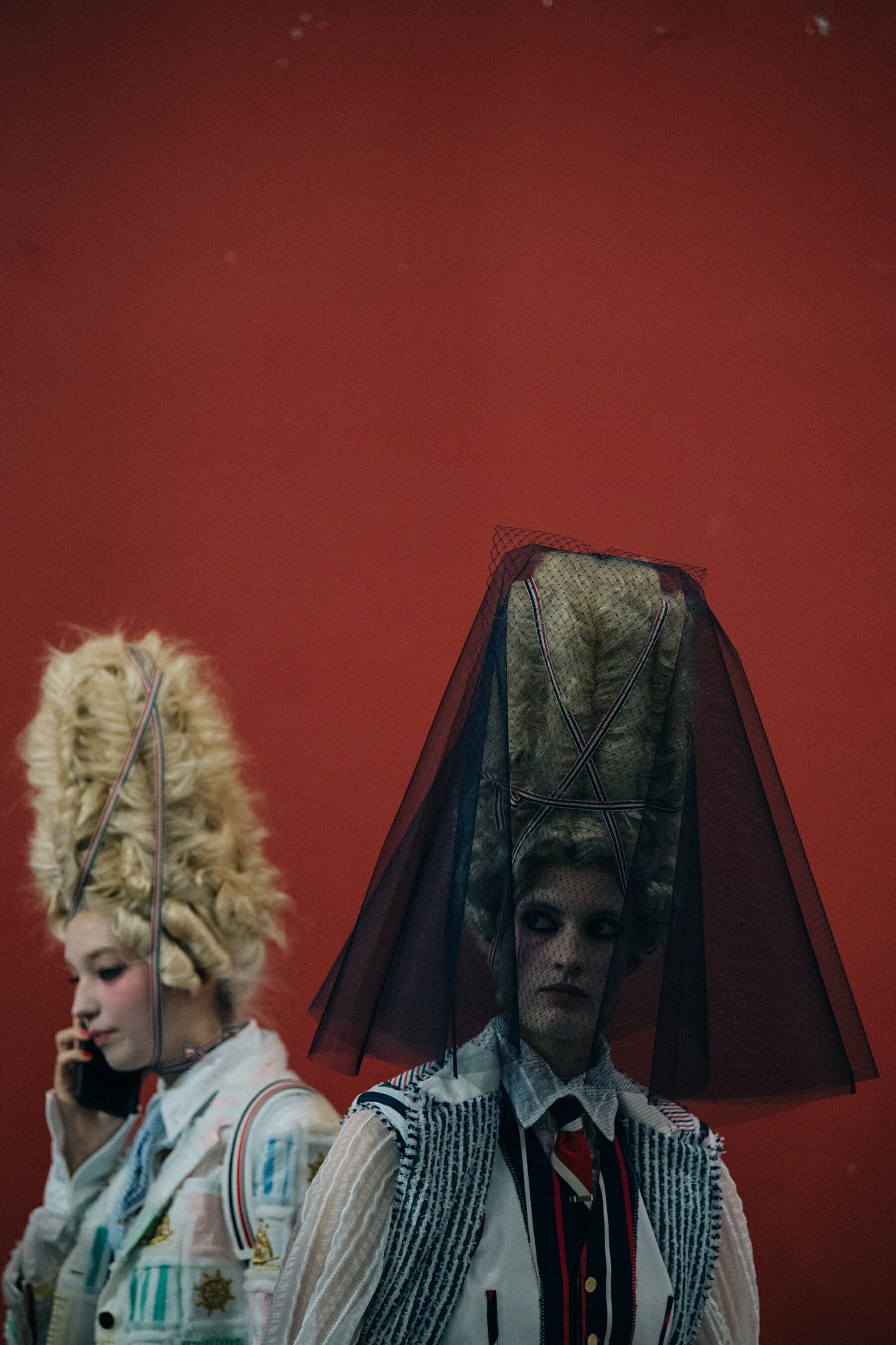 Models wearing tall wigs at Thom Browne