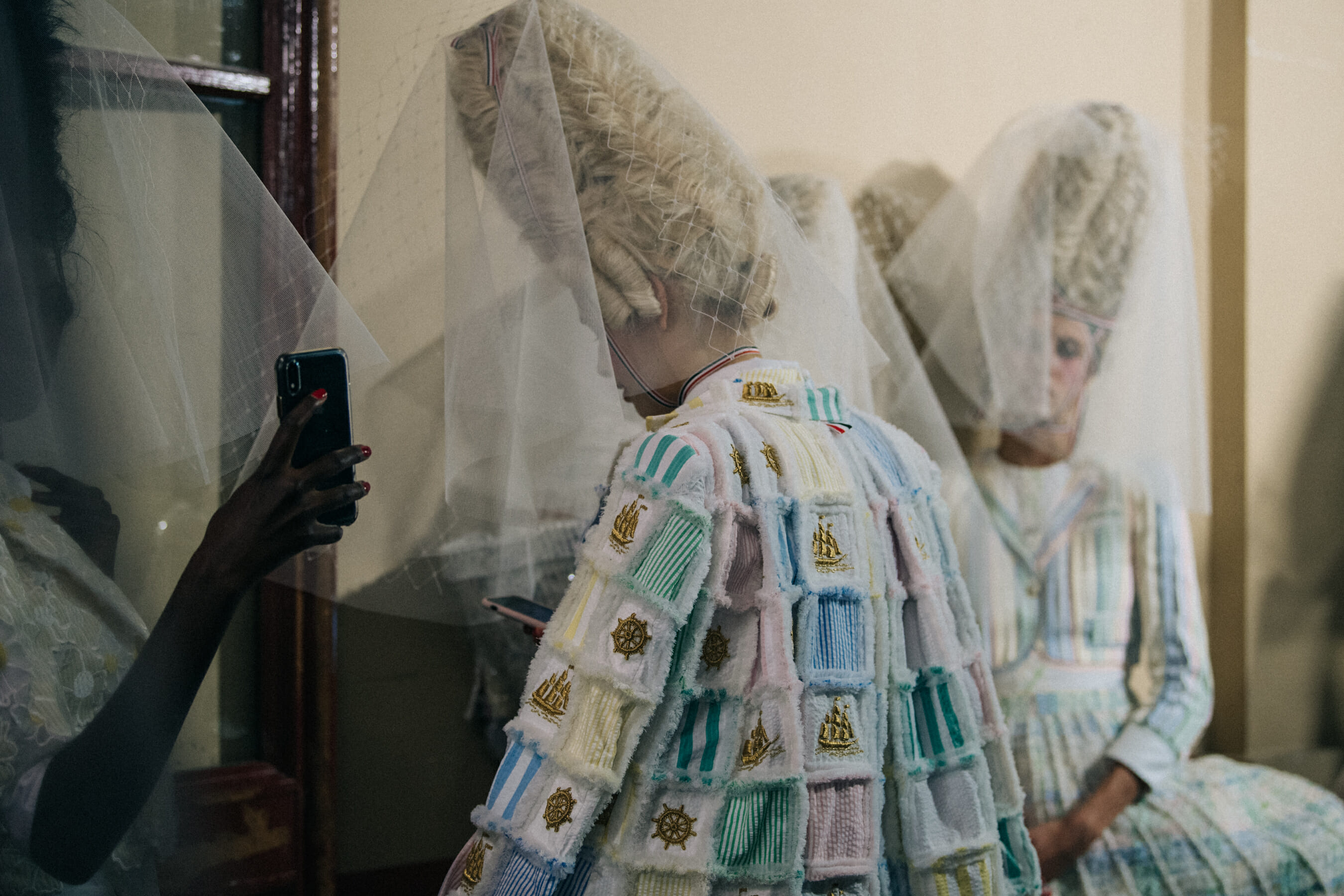 Models wearing tall wigs at Thom Browne
