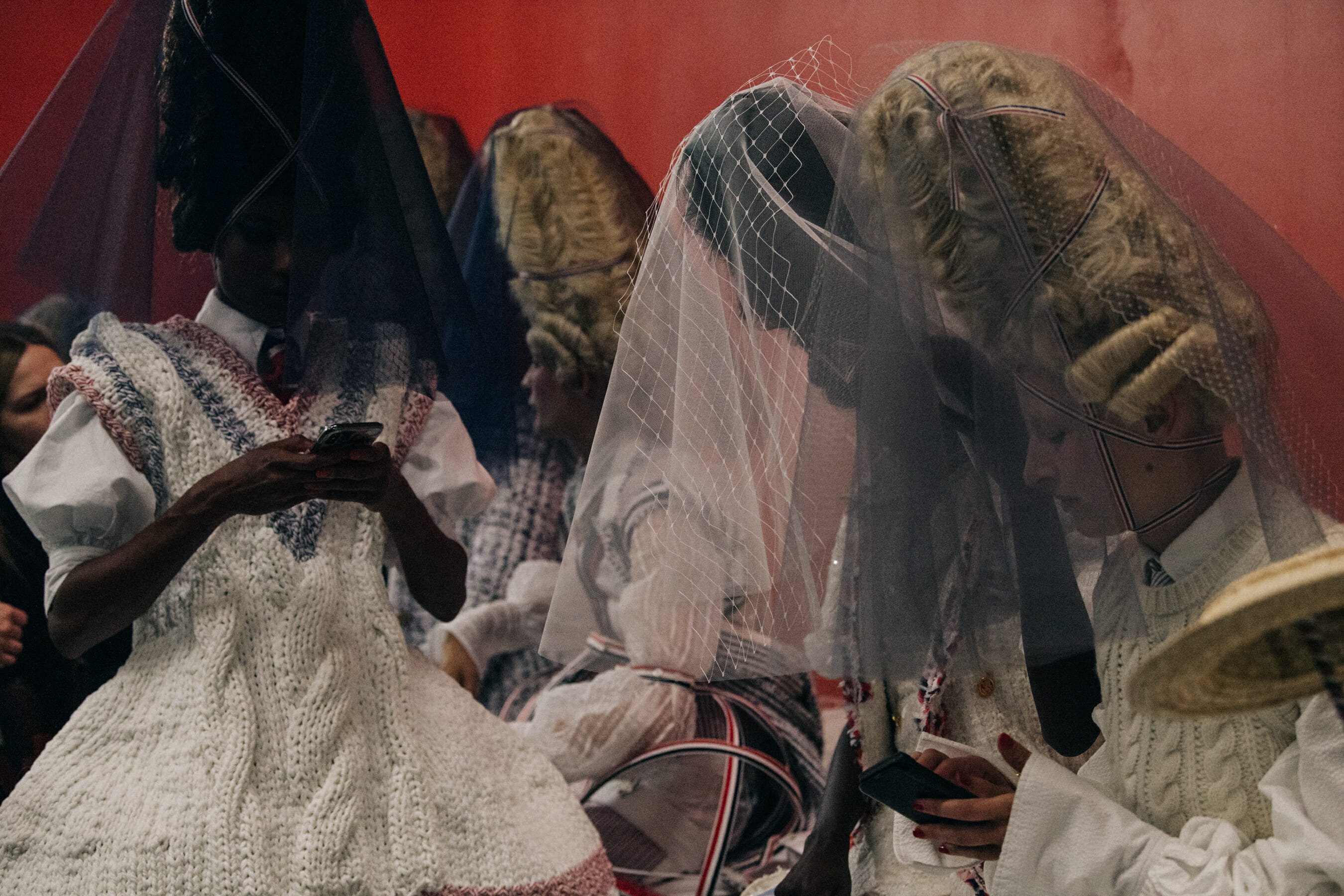 Models wearing tall wigs at Thom Browne