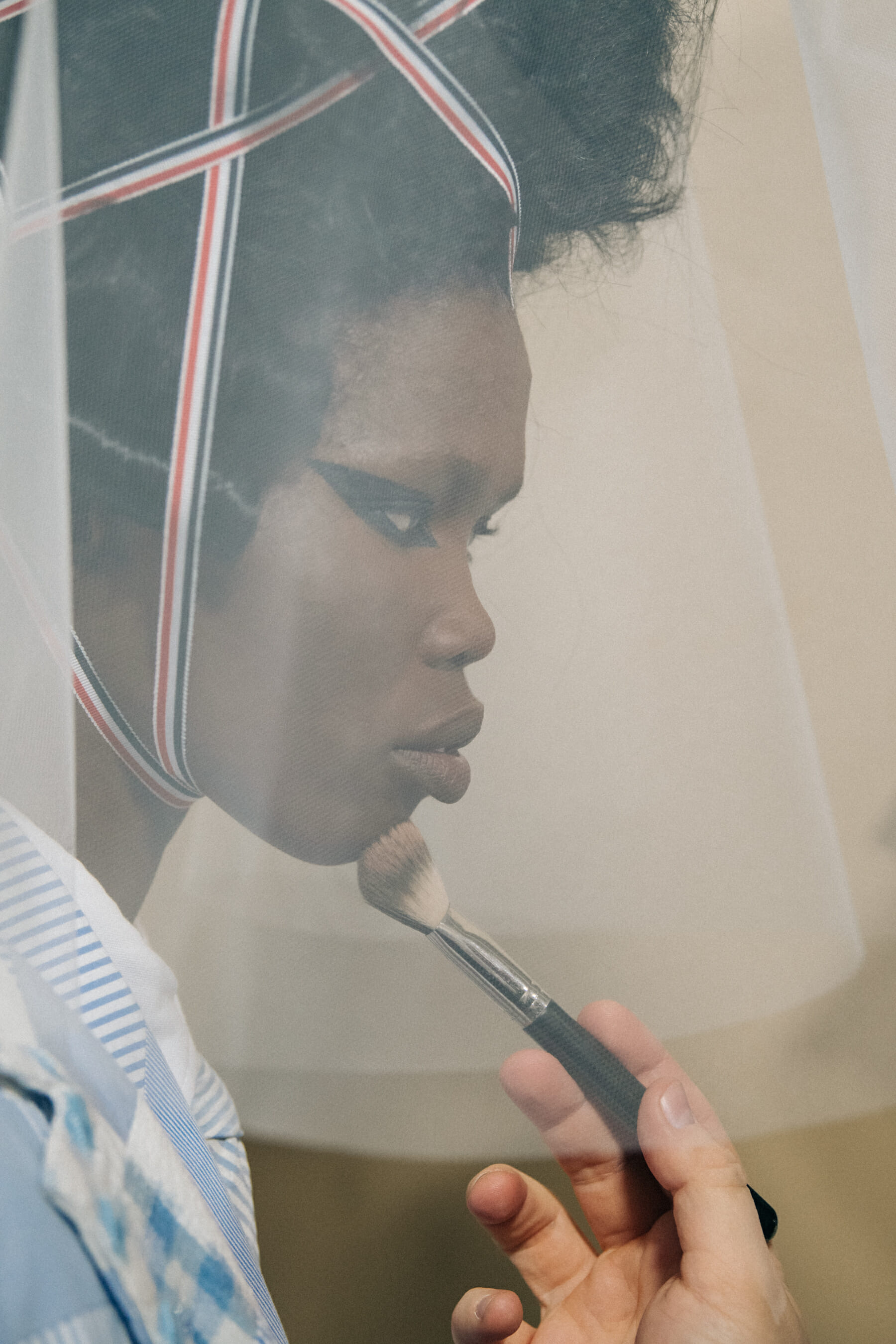 Models wearing tall wigs at Thom Browne