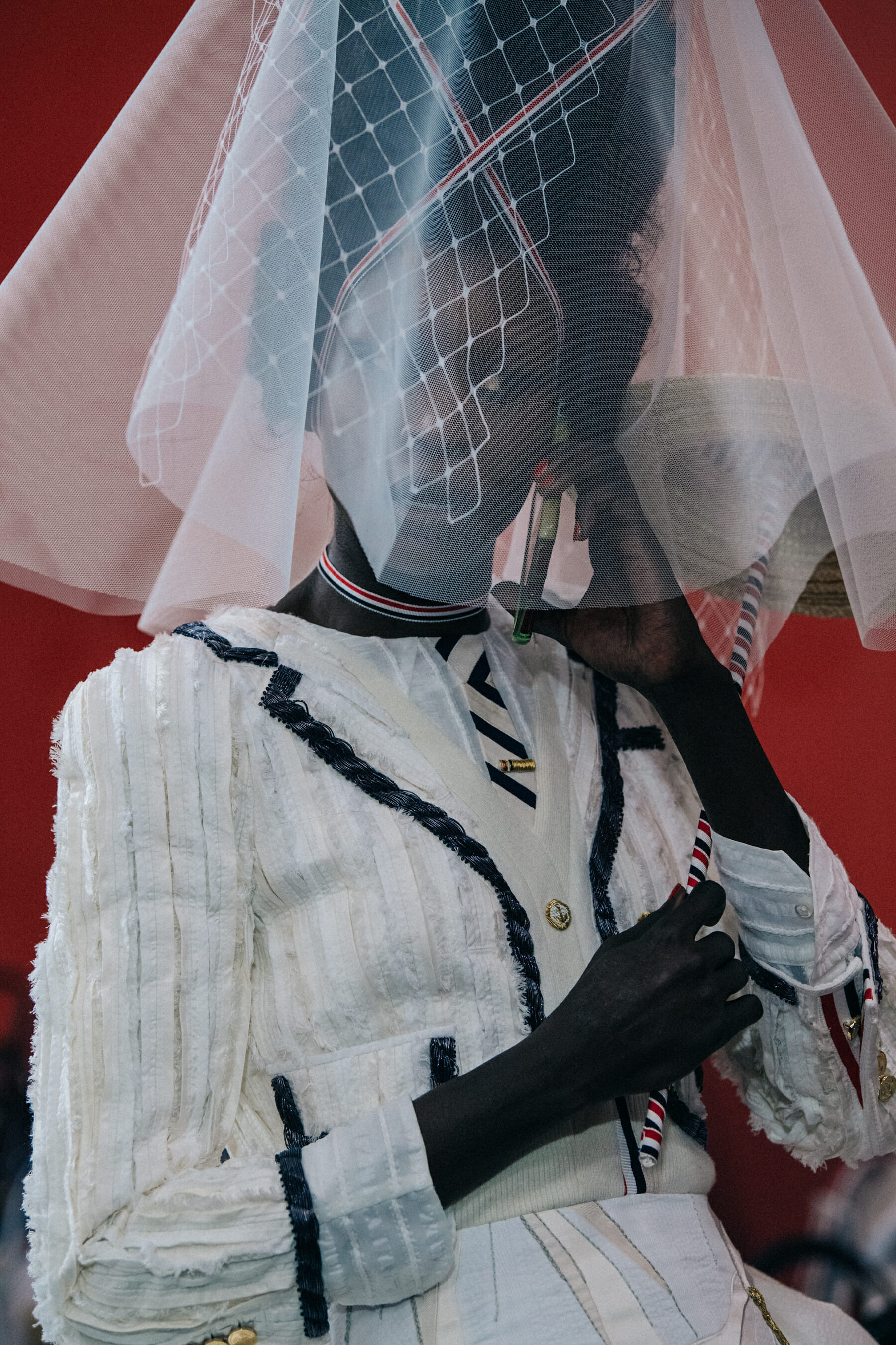 Models wearing tall wigs at Thom Browne