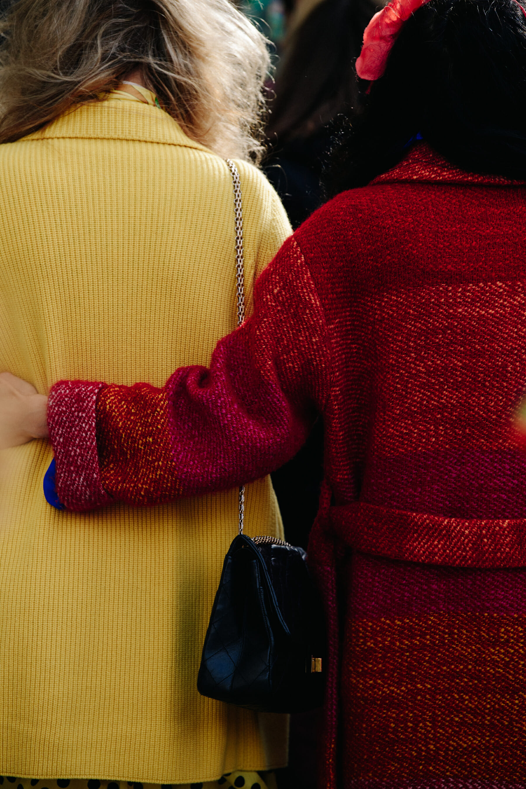 Two women wearing bright coats