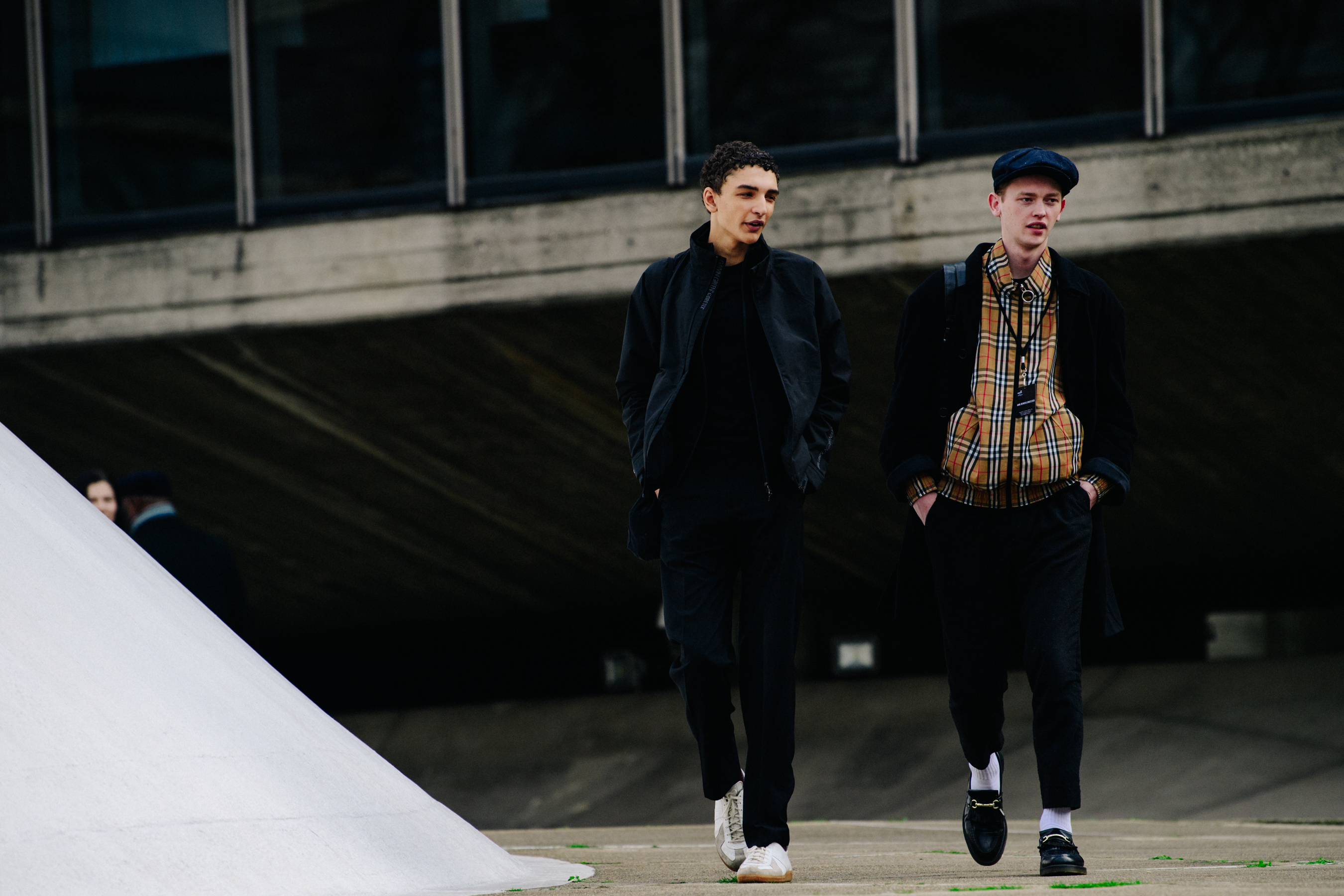 Two models wearing dark clothing