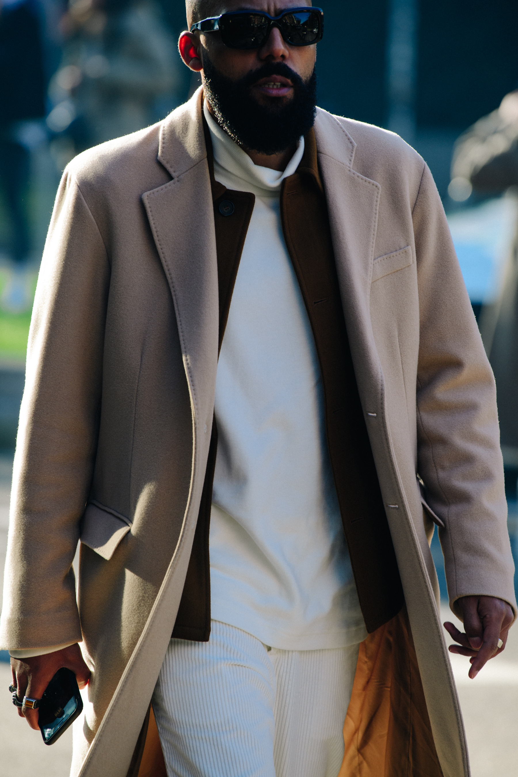 Man wearing long tan coat