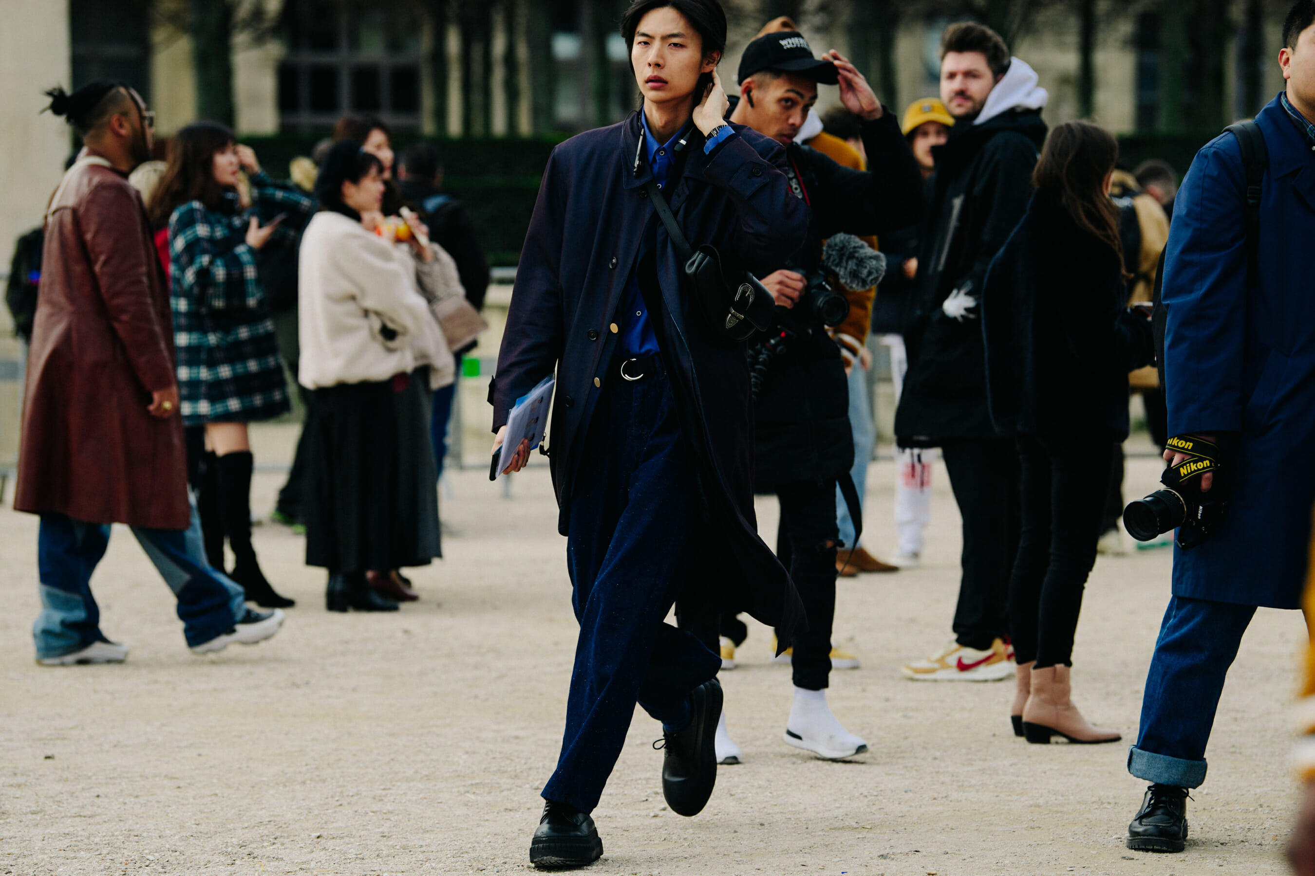 Model wearing long navy coat