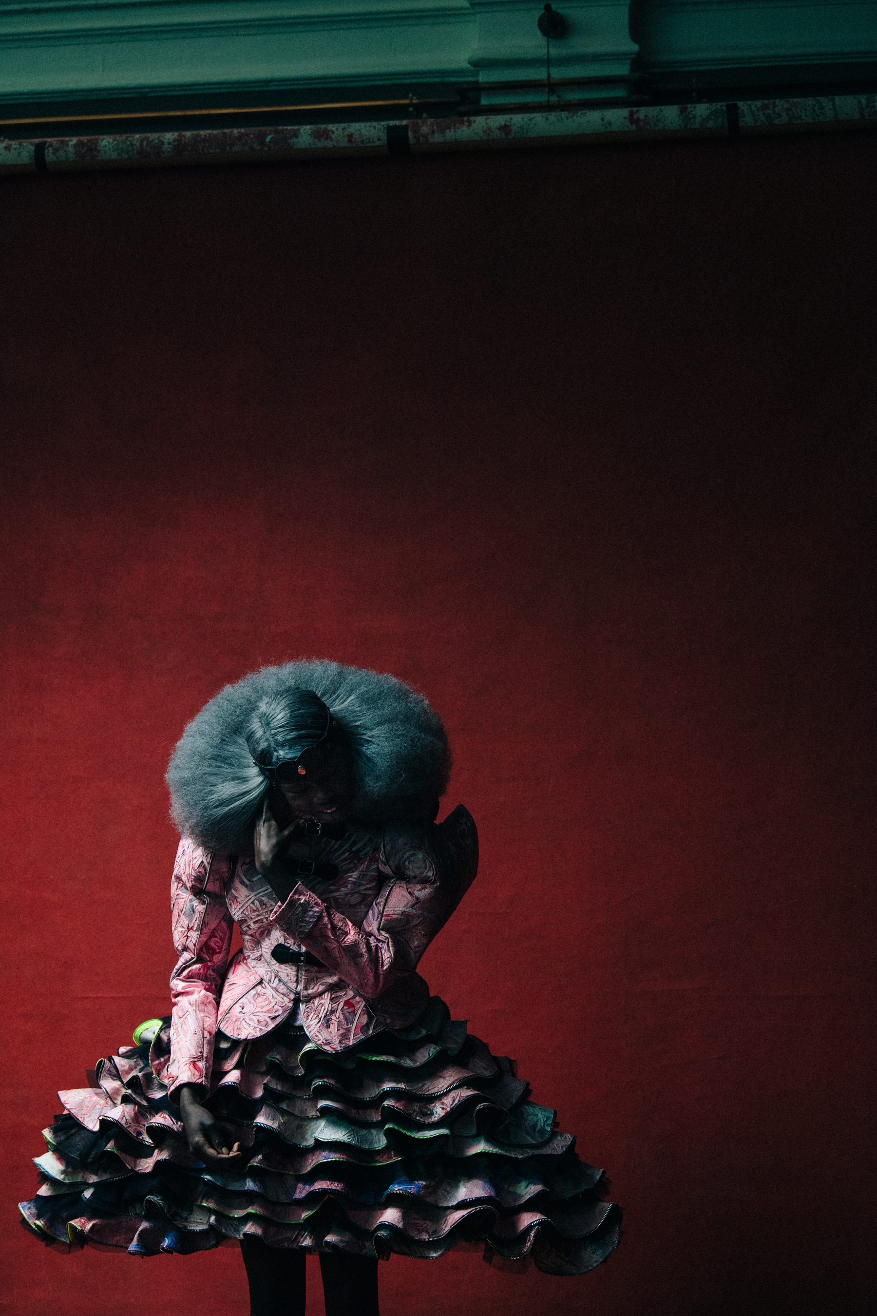 Model wearing pink dress backstage