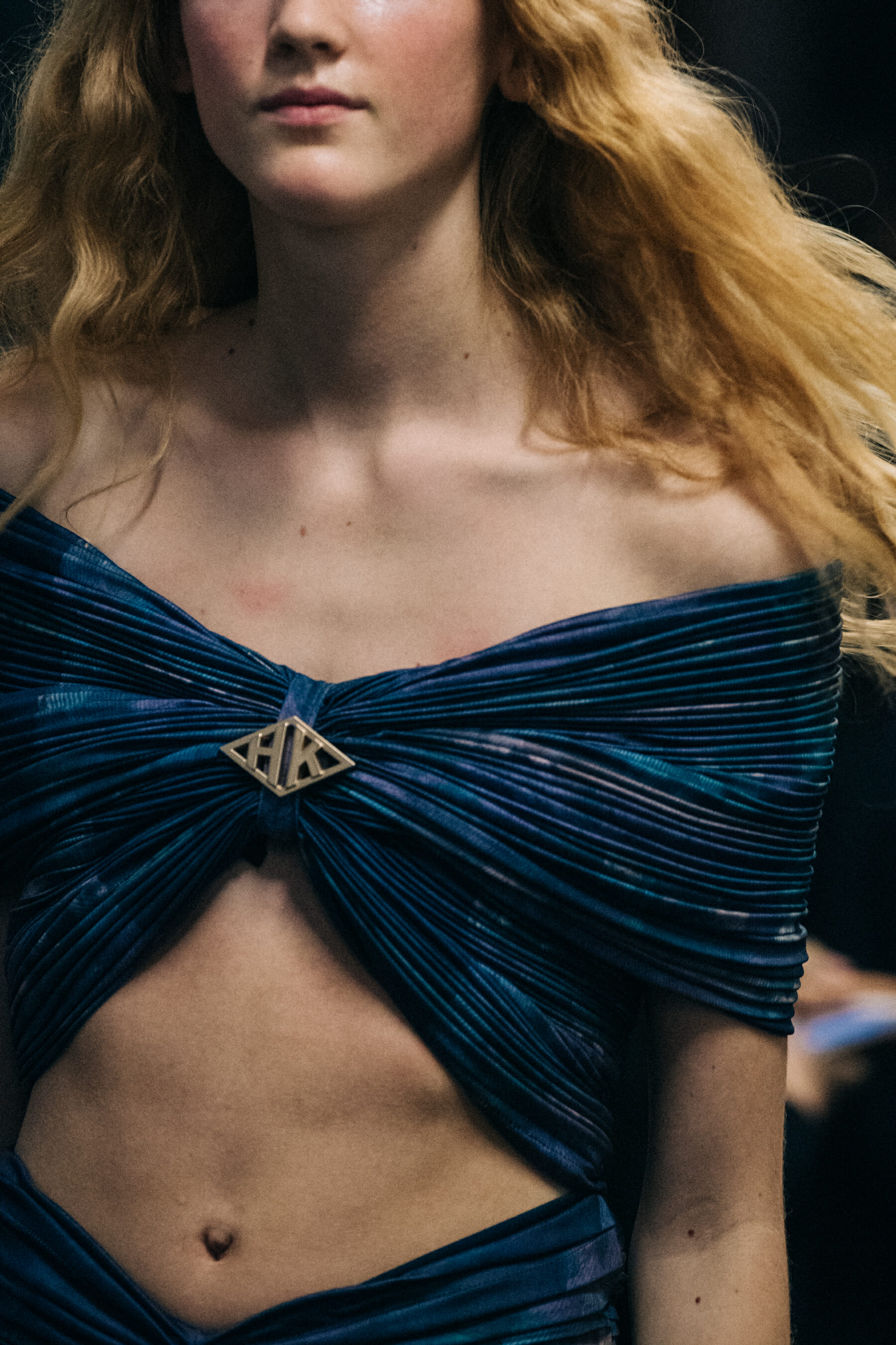 Model wearing dark outfit backstage