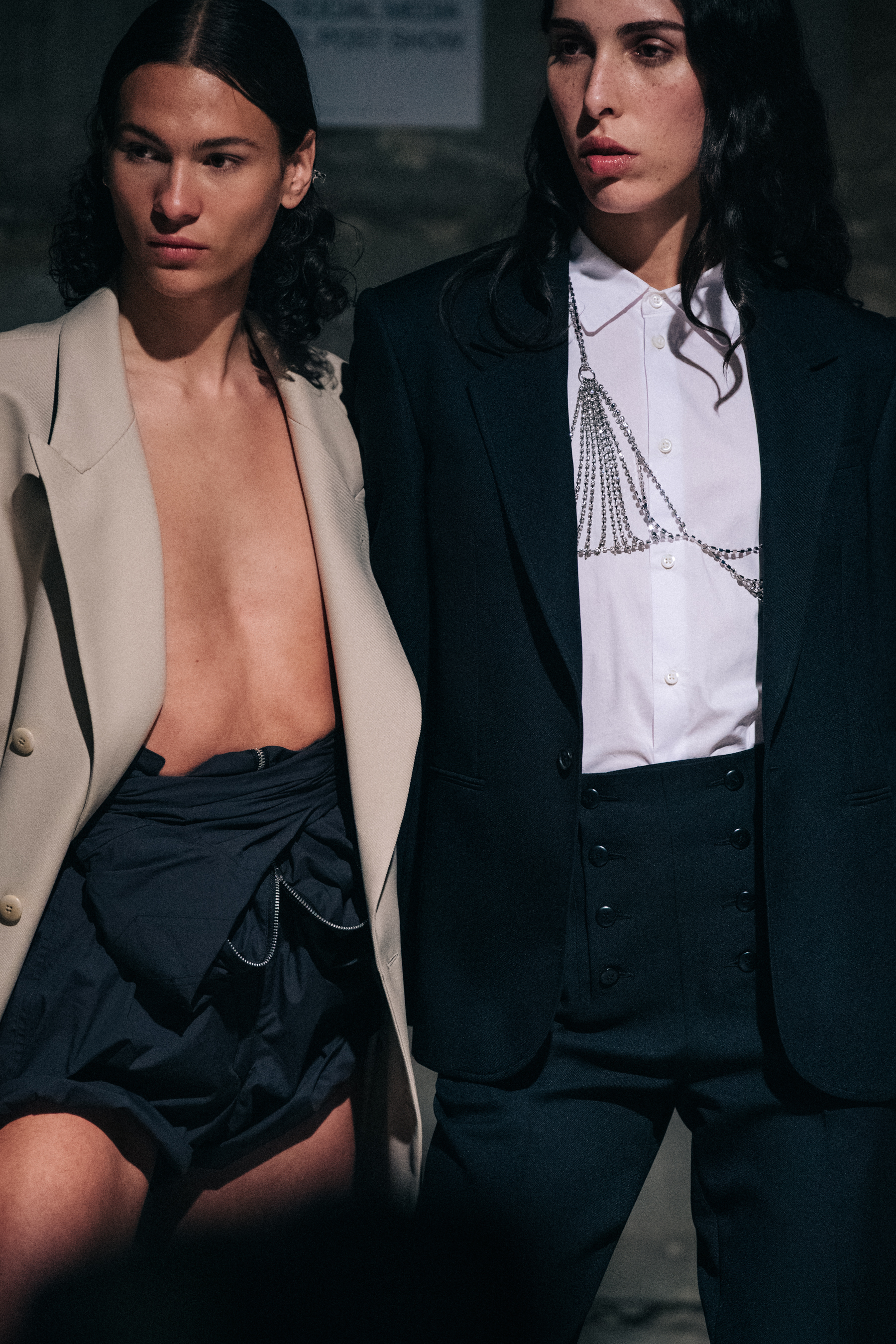 Models backstage wearing suits