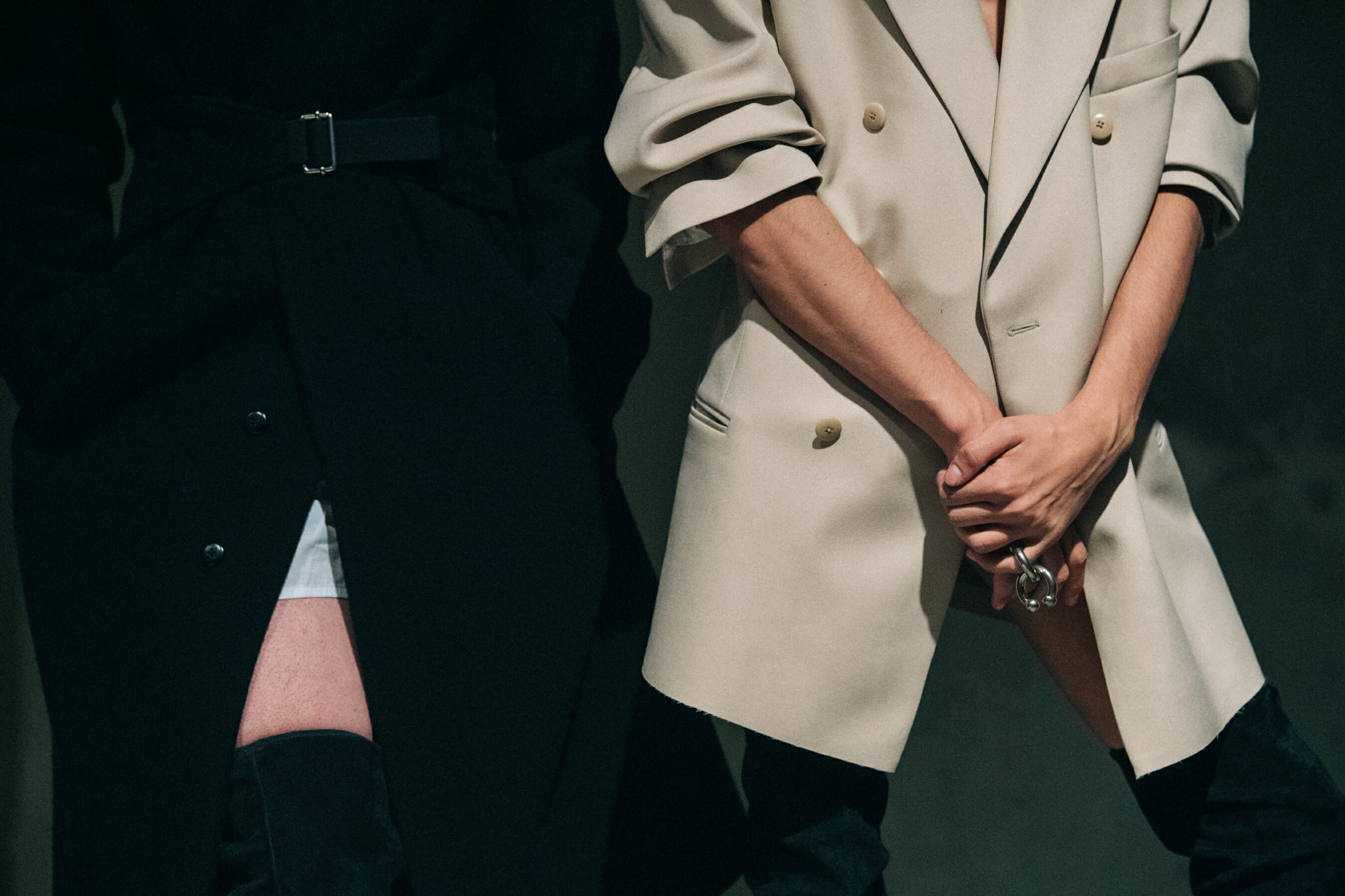 Models backstage wearing suits