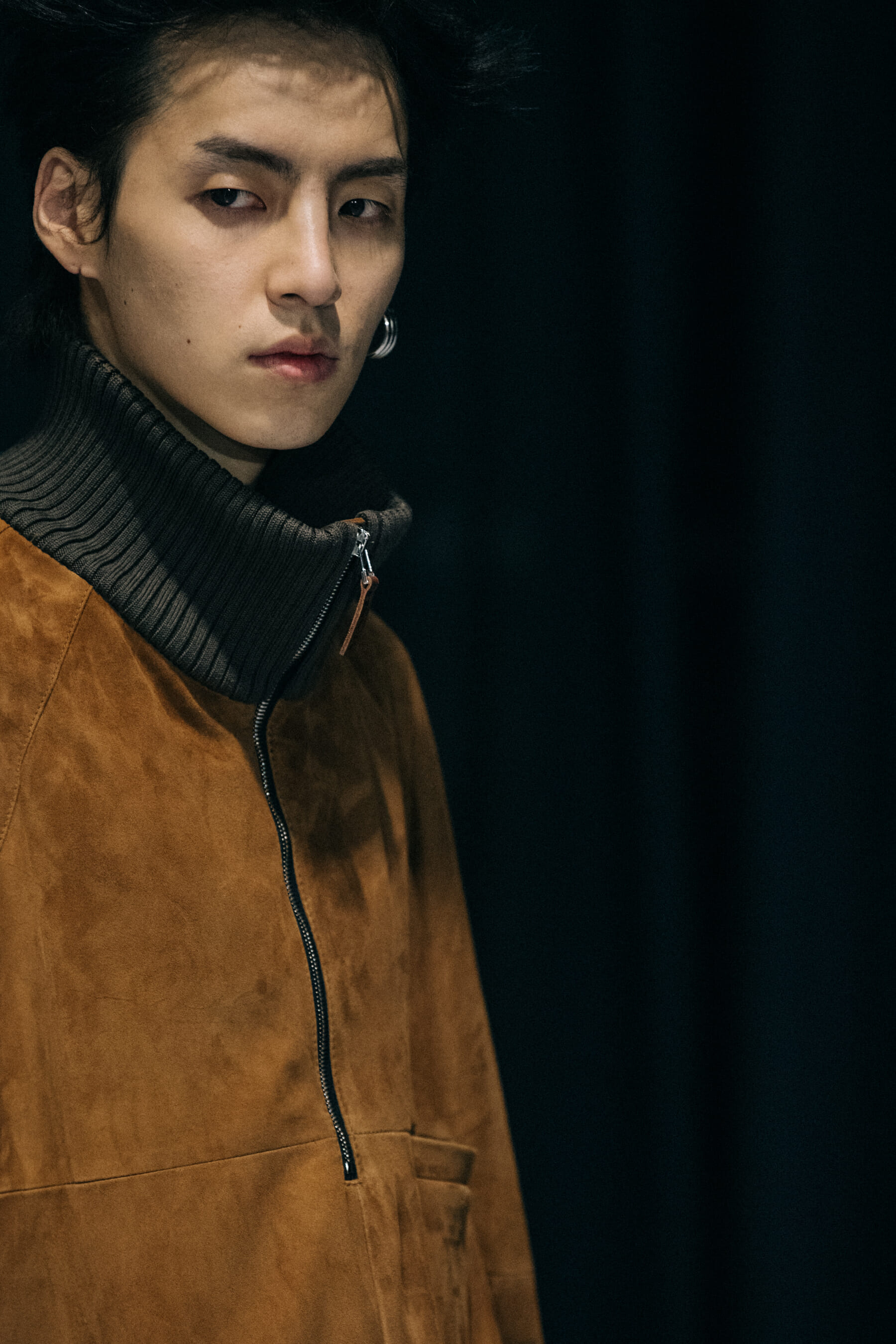 Model wearing brown jacket backstage