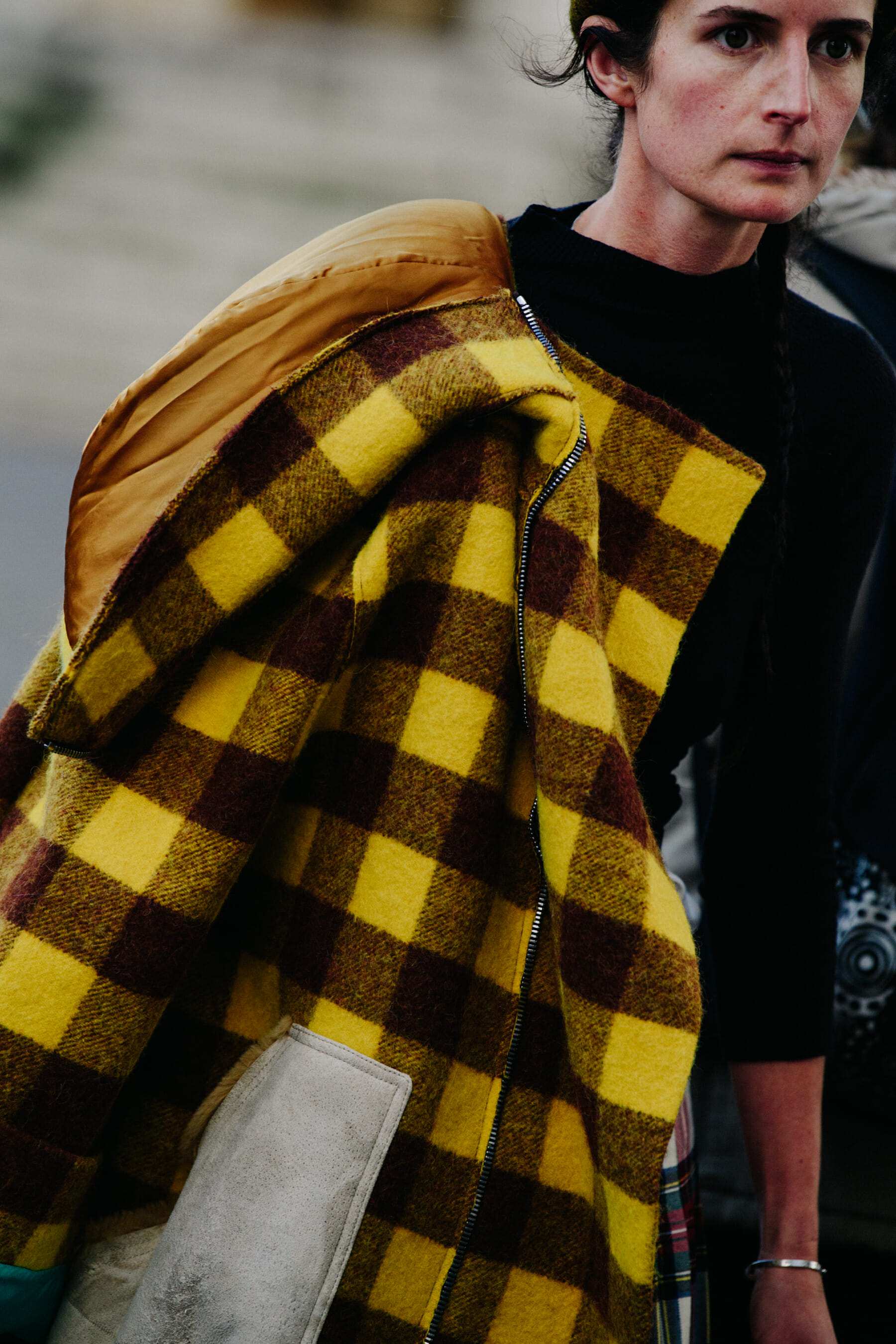 Woman carrying yellow coat