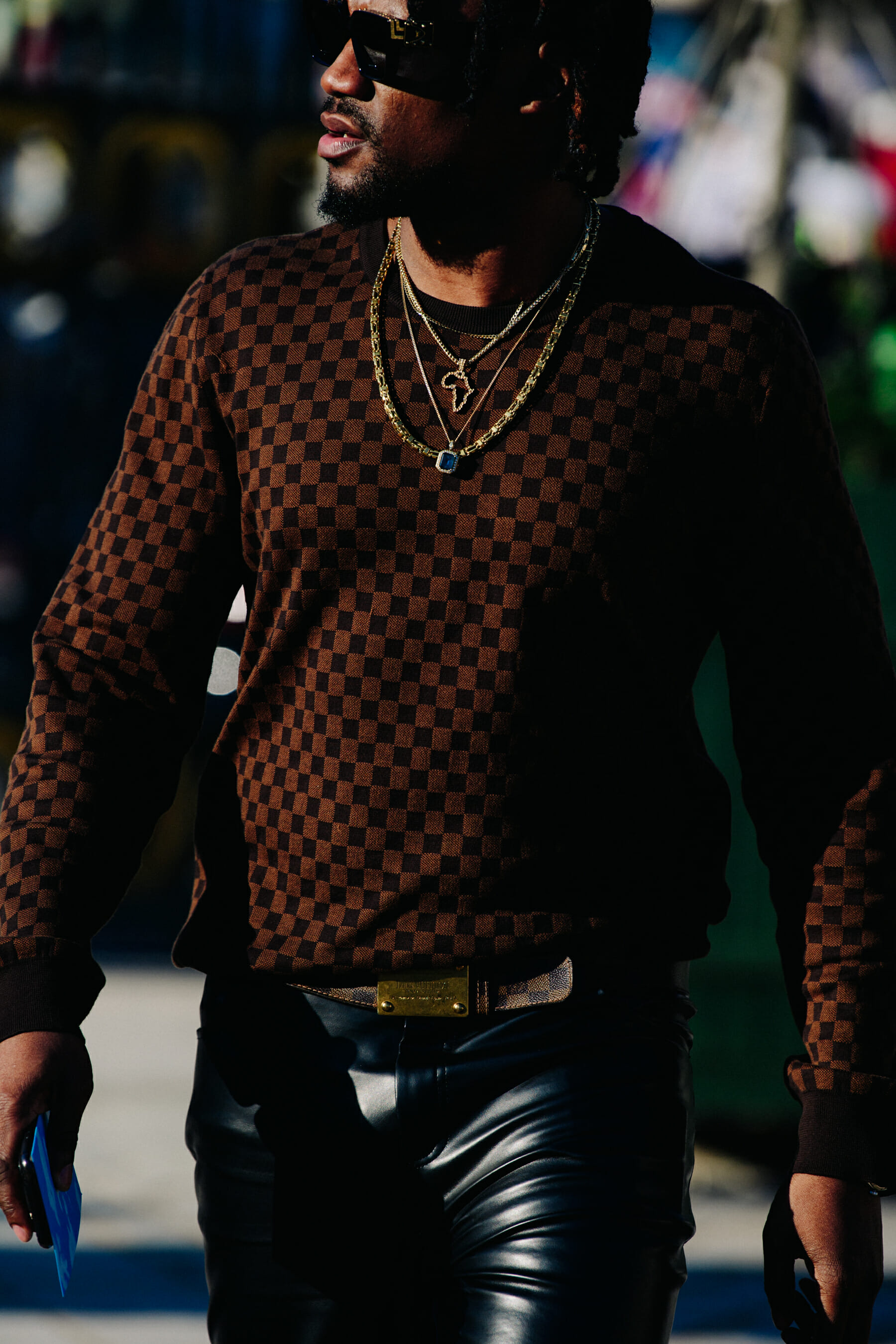 Man wearing brown check top