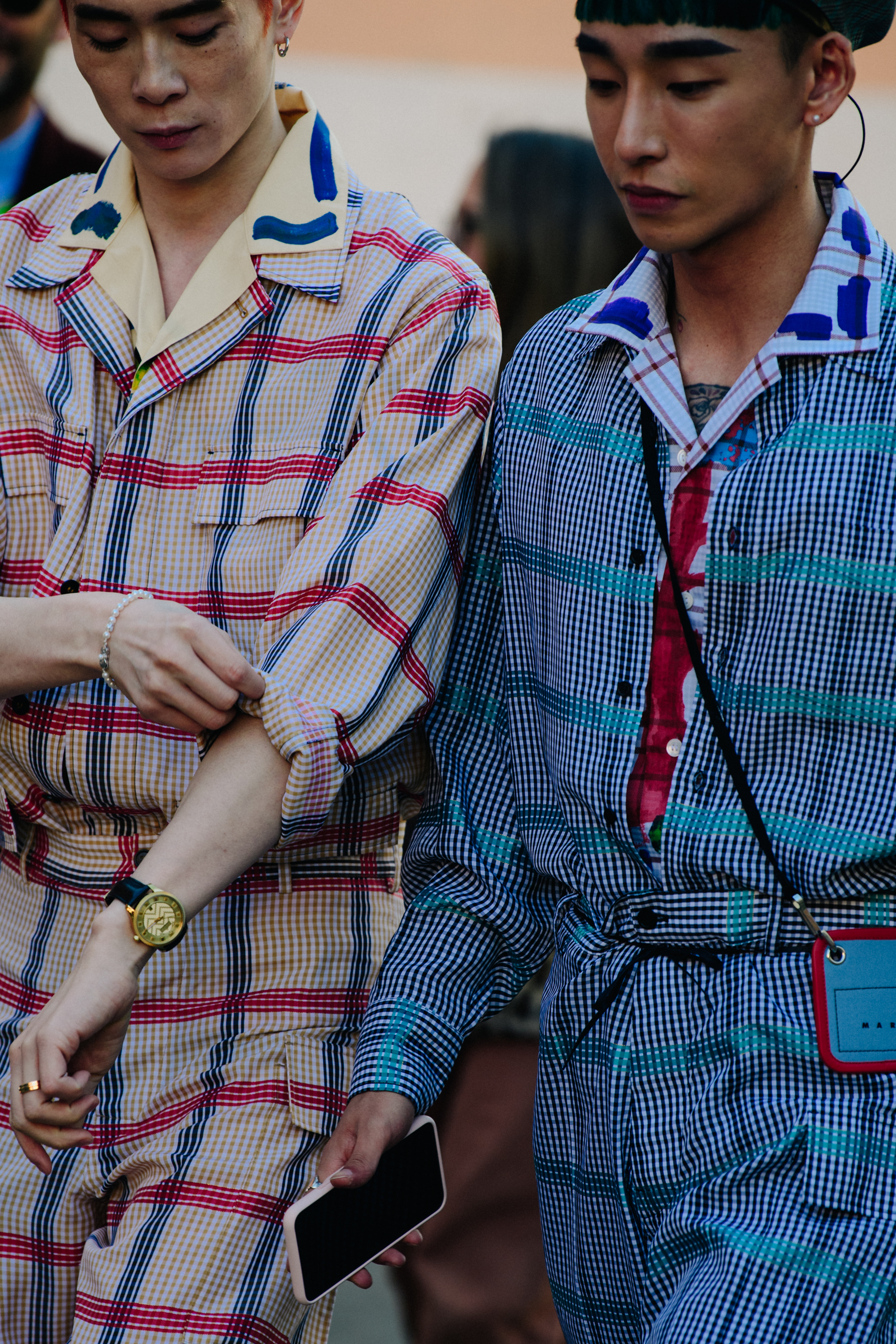 Two Asian men wearing matching clothing