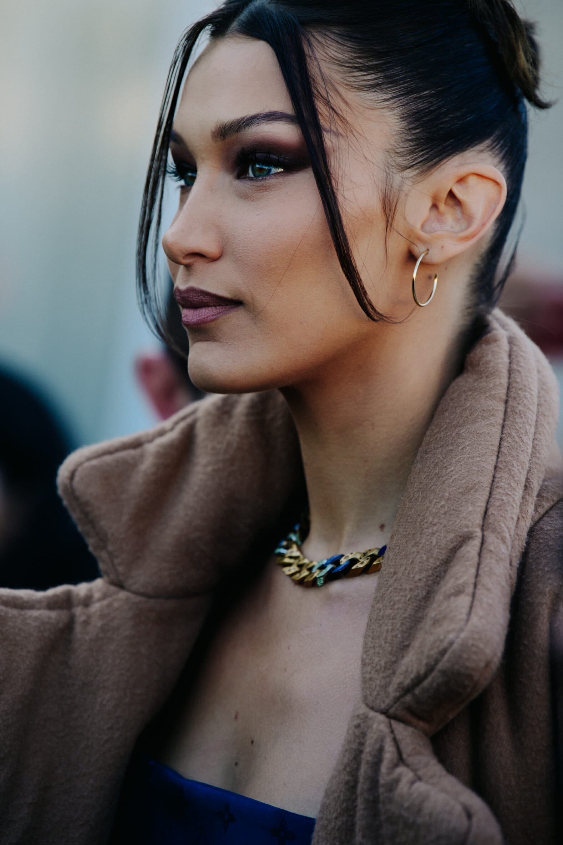 Supermodel wearing brown coat