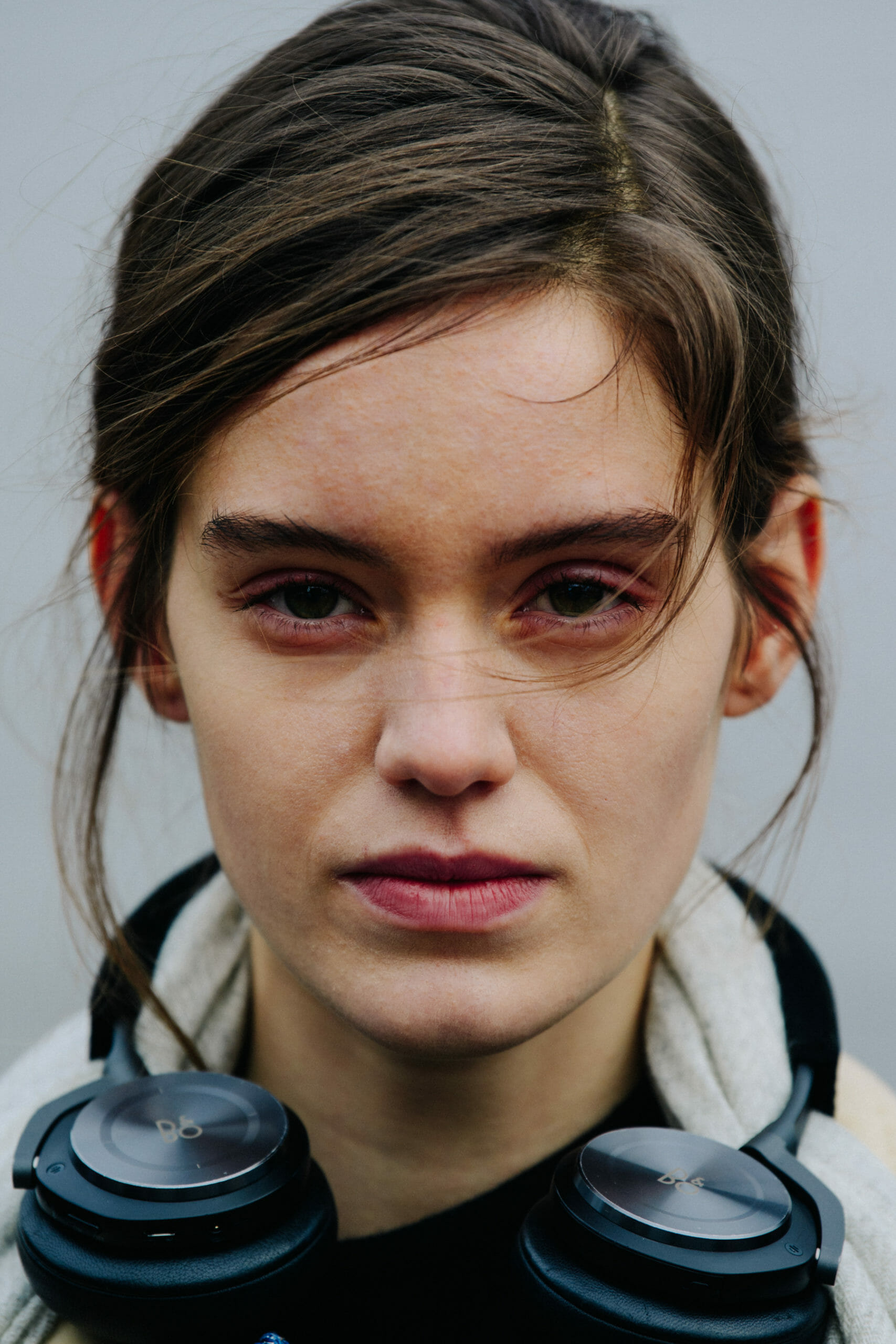 Model wearing Bang & Olufsen headphones
