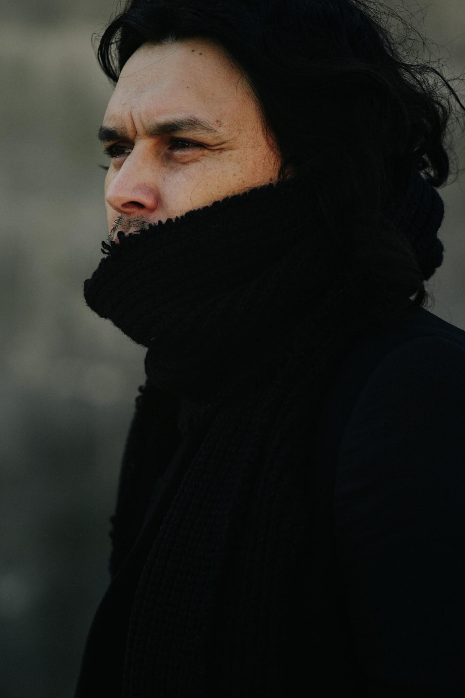 Designer wearing black scarf