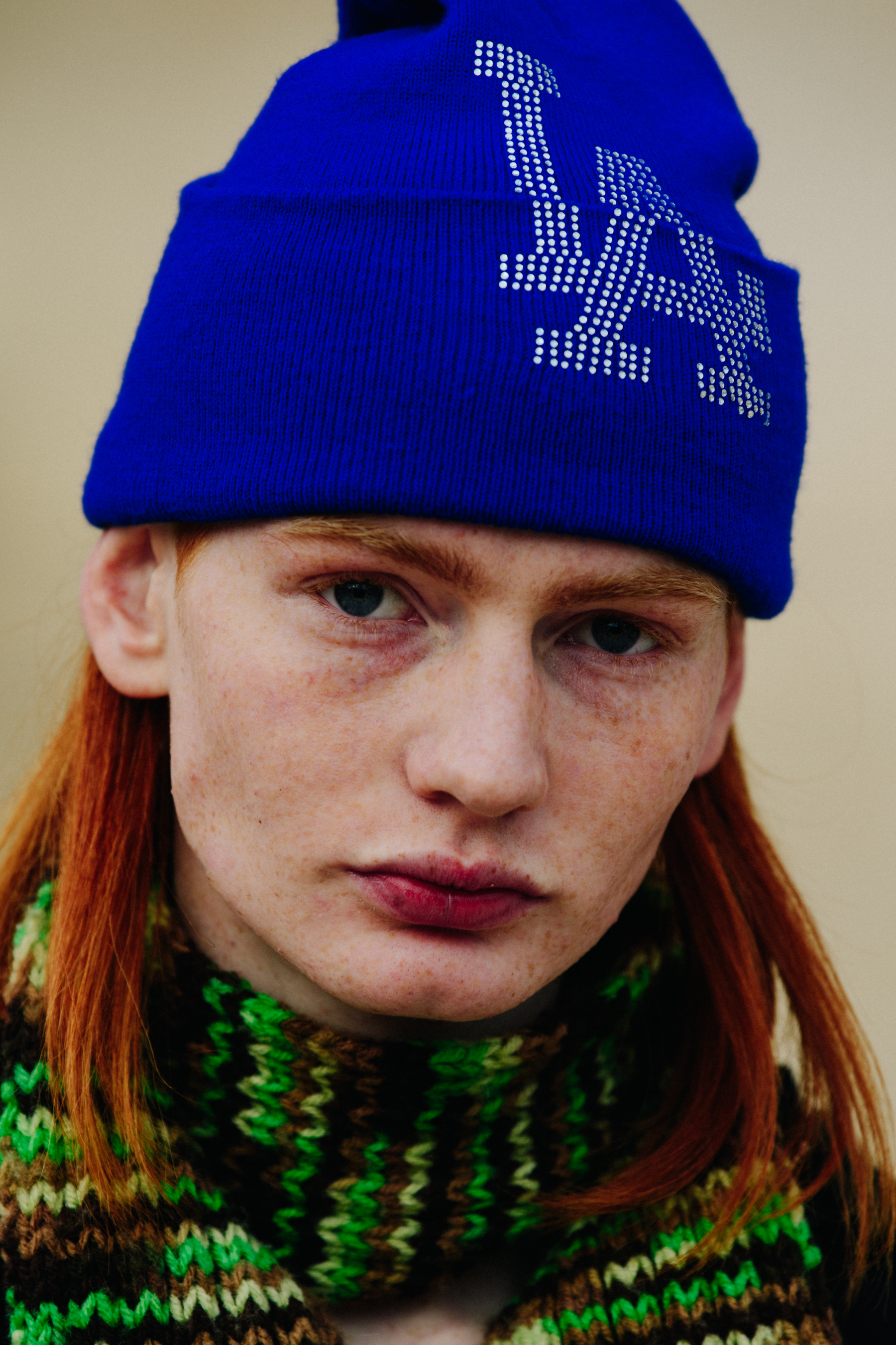 Model wearing blue beanie