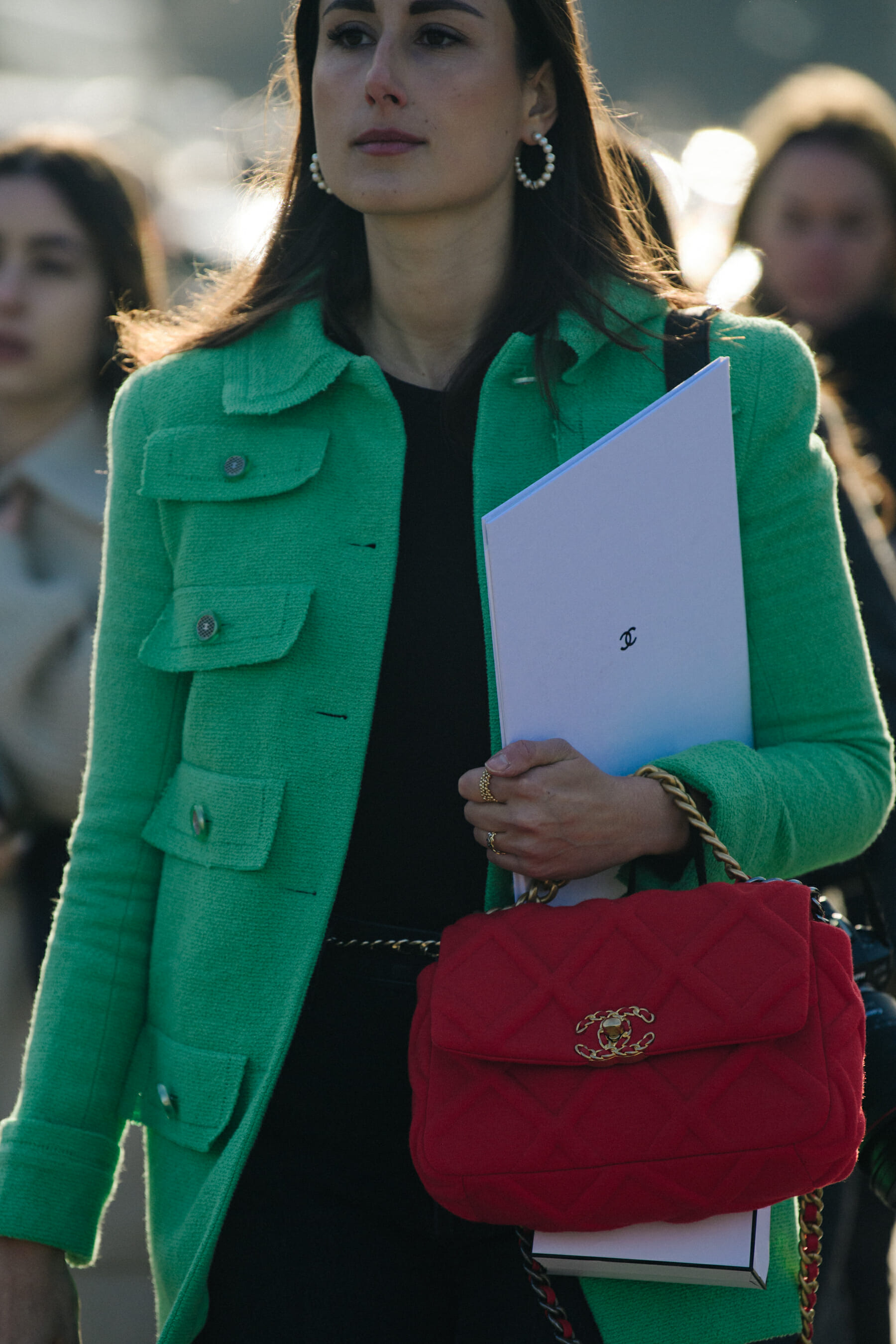 Woman wearing green Chanel jacket