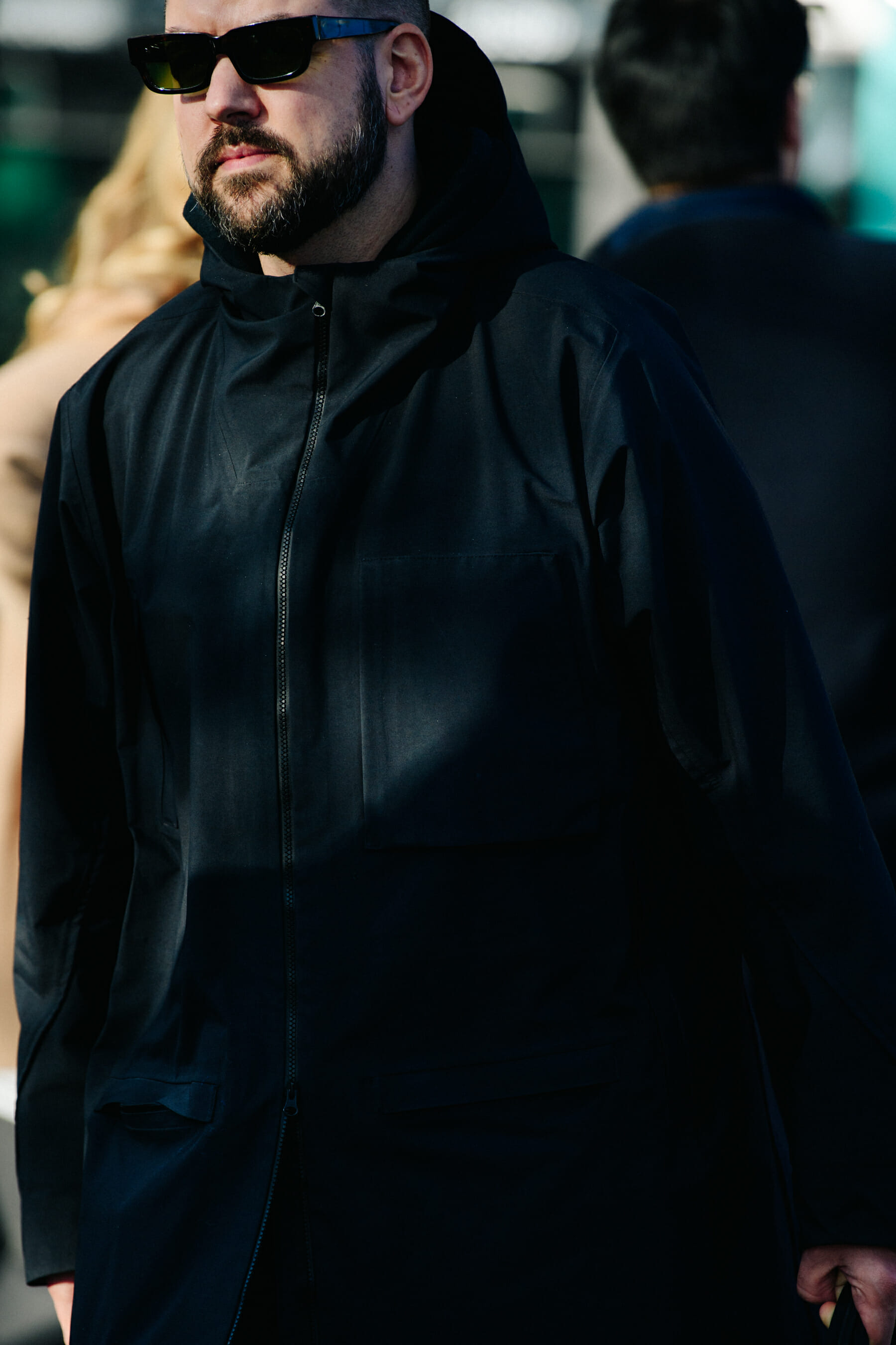 Man wearing black raincoat