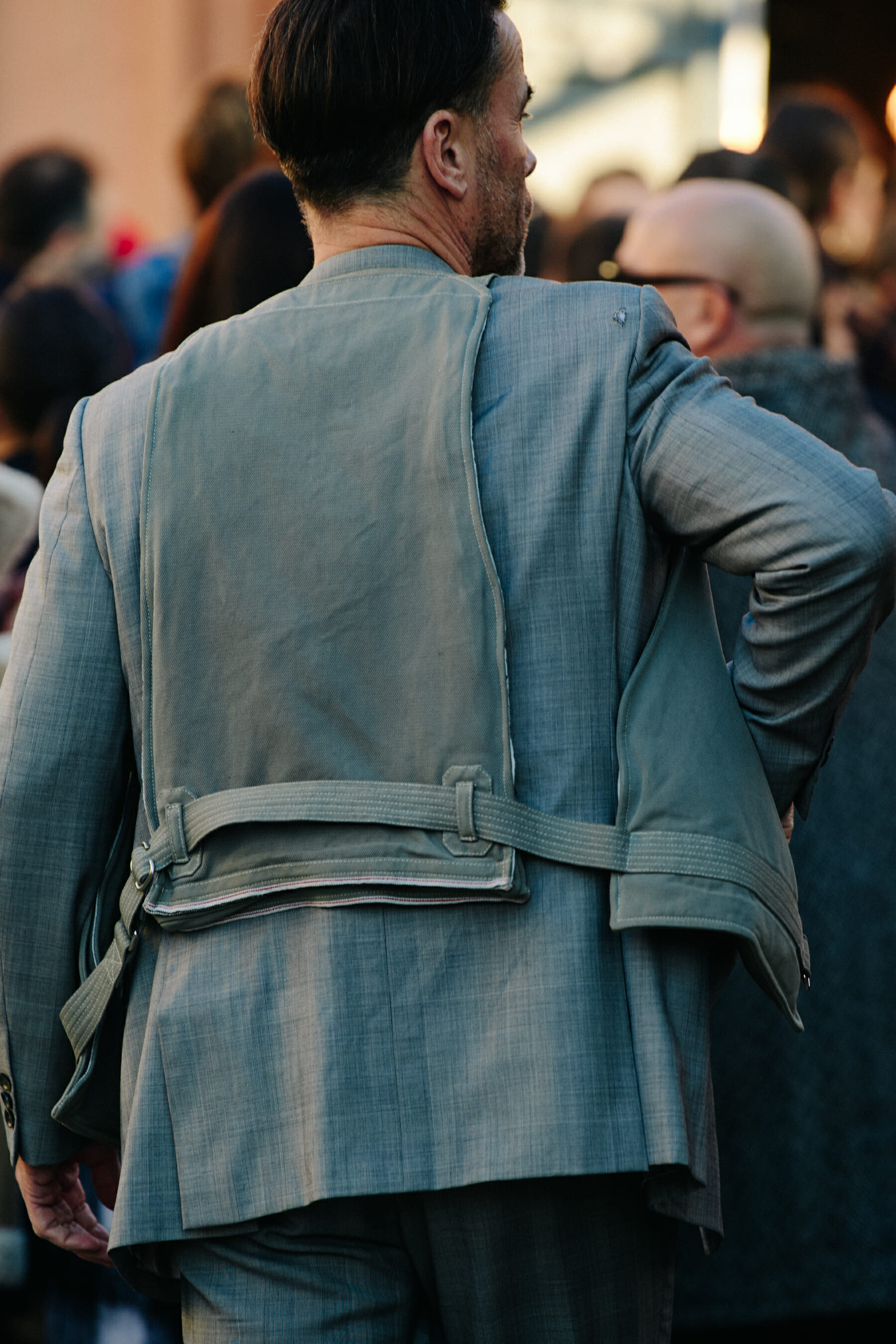Man wearing grey vest